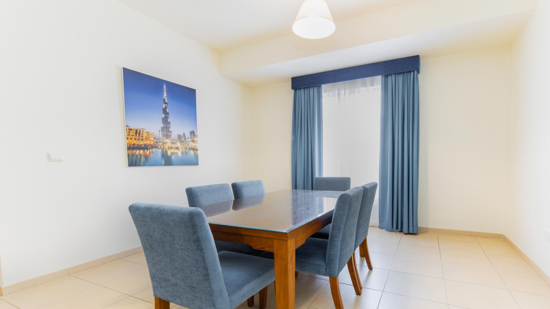 Living room in serviced apartment, Jumeirah Beach Residence, Amwaj. Cozy blue sofas, bright ambiance