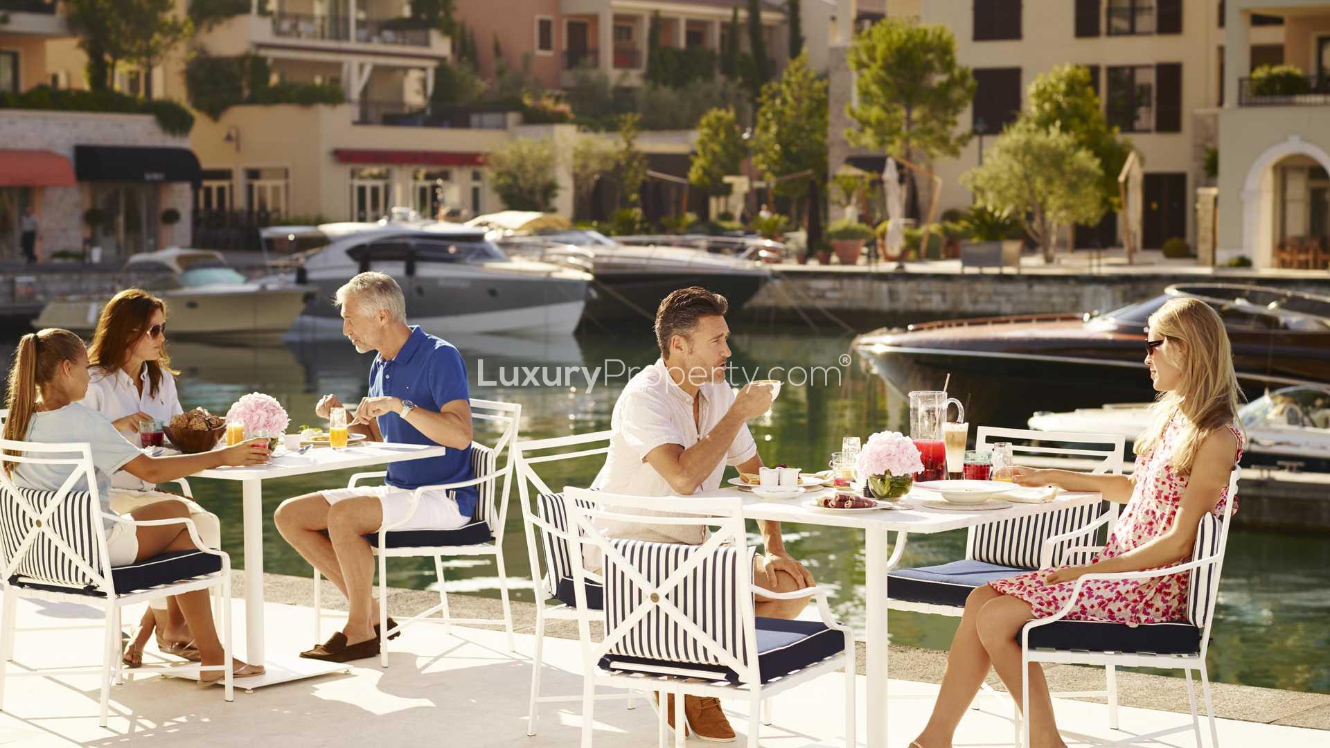 Luxurious waterfront residences at Regent Pool Club, Porto Montenegro, evening view with boats