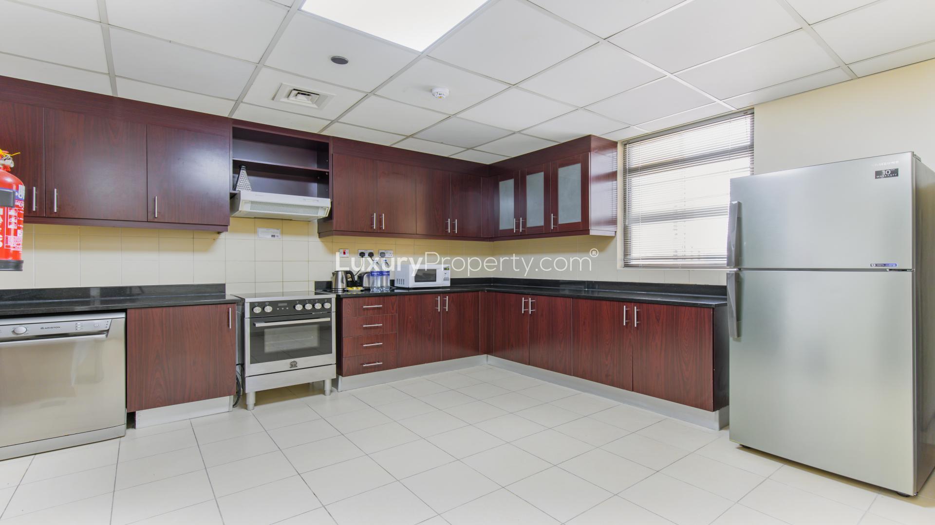 Spacious living room with blue sofas in JBR Amwaj serviced apartment for rent