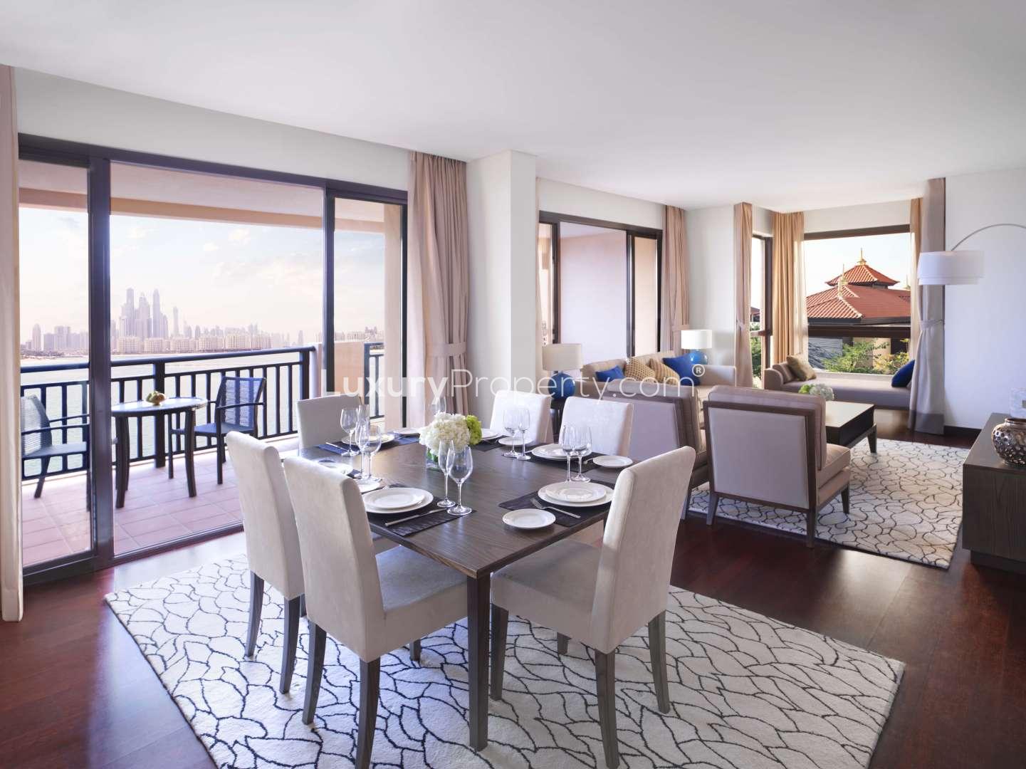 Balcony view of pool and lush gardens at Anantara Residences, Palm Jumeirah apartment