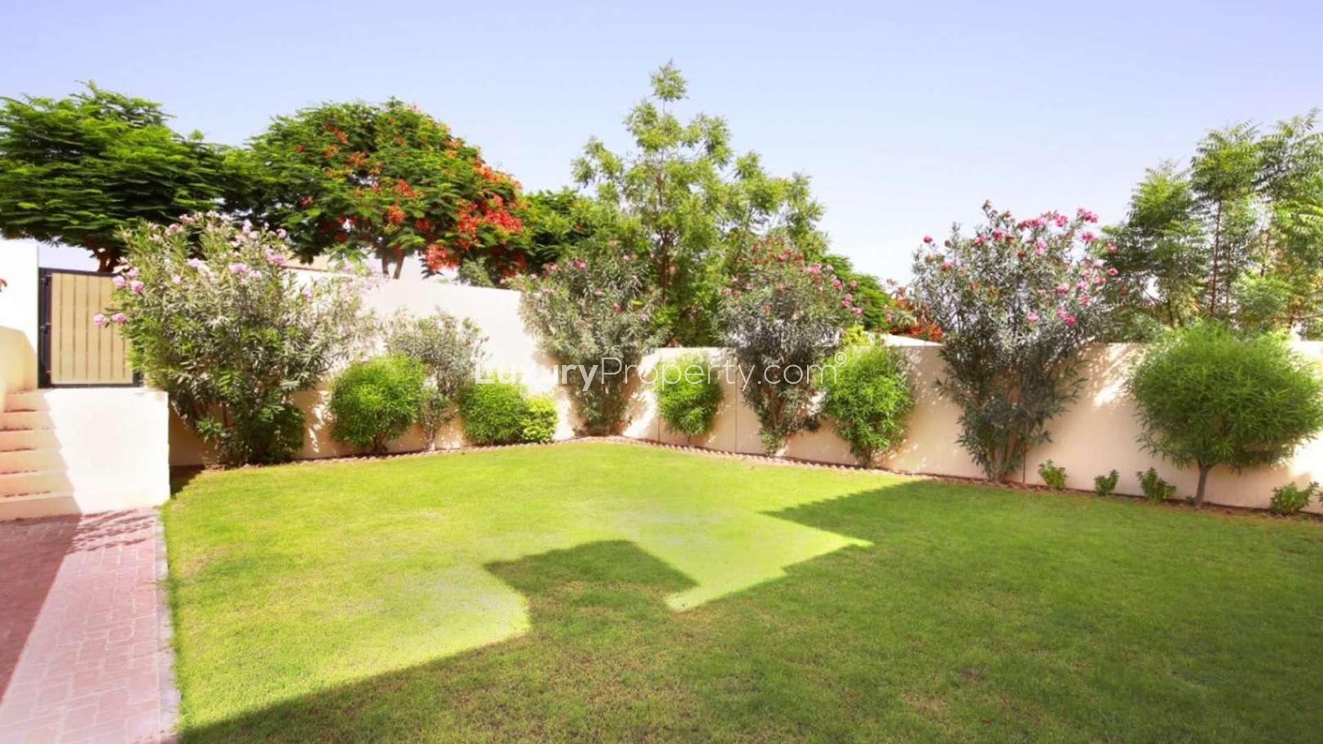 Townhouse exterior with lush green gardens, Alma sub-community, Arabian Ranches
