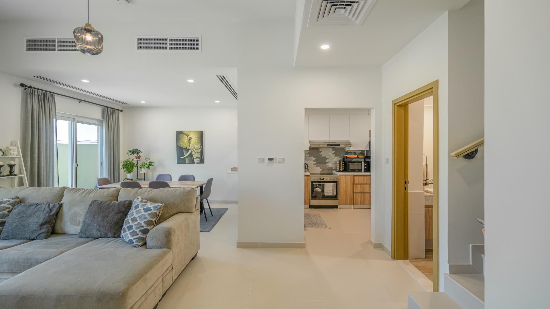 Dining area with garden view in Villanova townhouse, Dubai Land