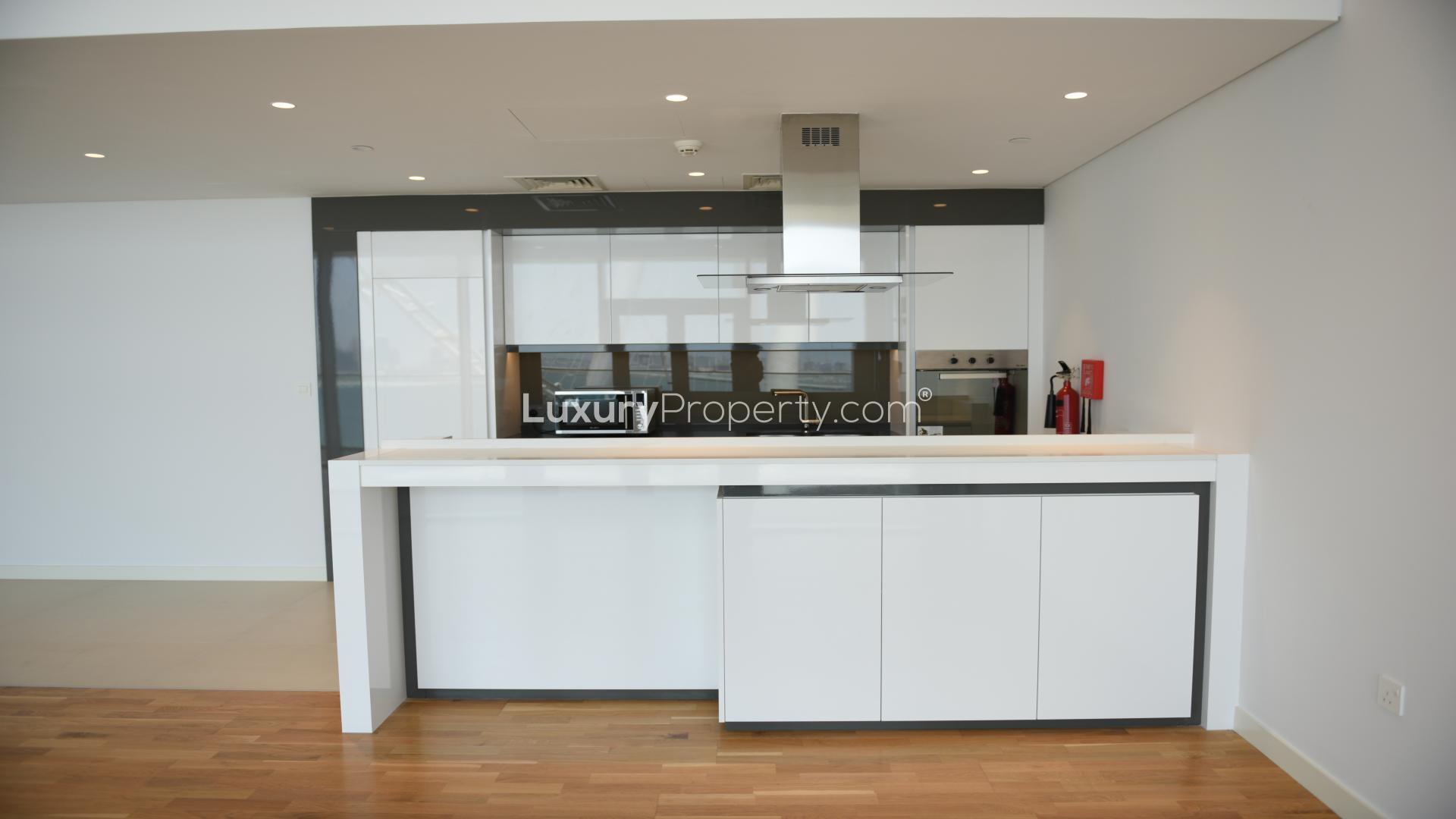Modern kitchen in Bluewaters Residences apartment, featuring sleek cabinetry and open layout design