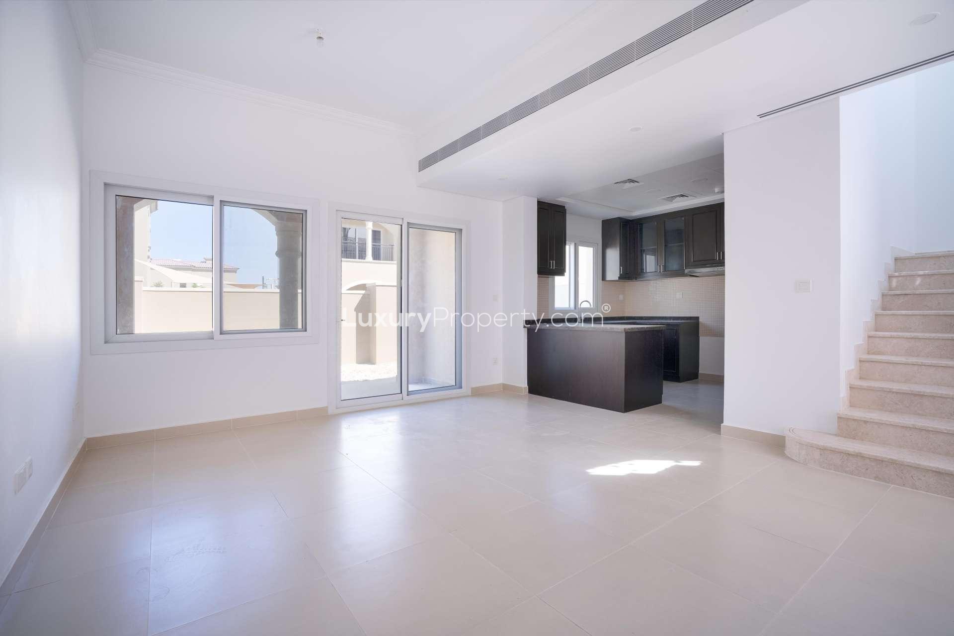Newly built kitchen in Serena Casa Dora townhouse with modern dark wood cabinets