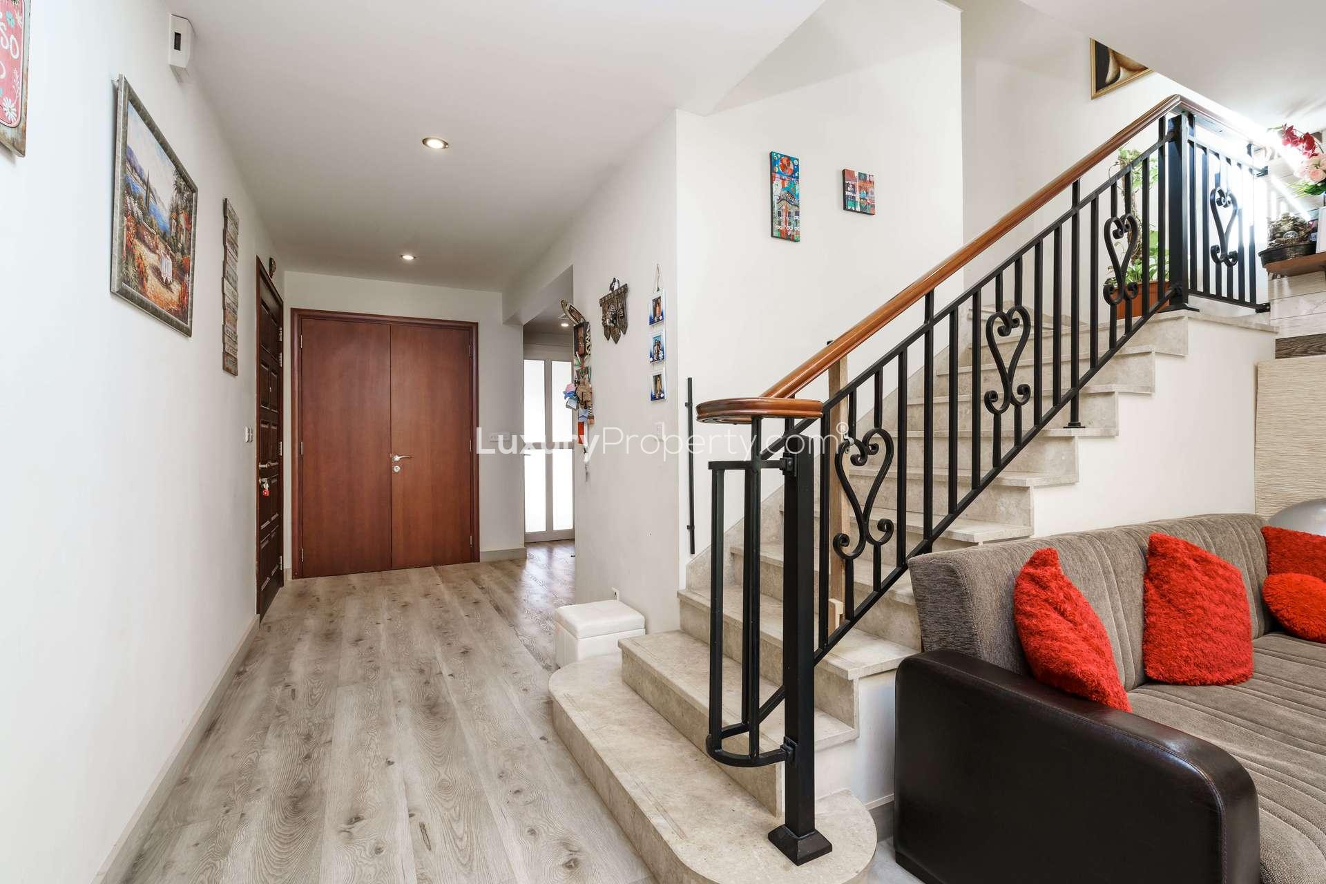 Bedroom in renovated Palmera Villa, Arabian Ranches, featuring elegant decor and balcony view