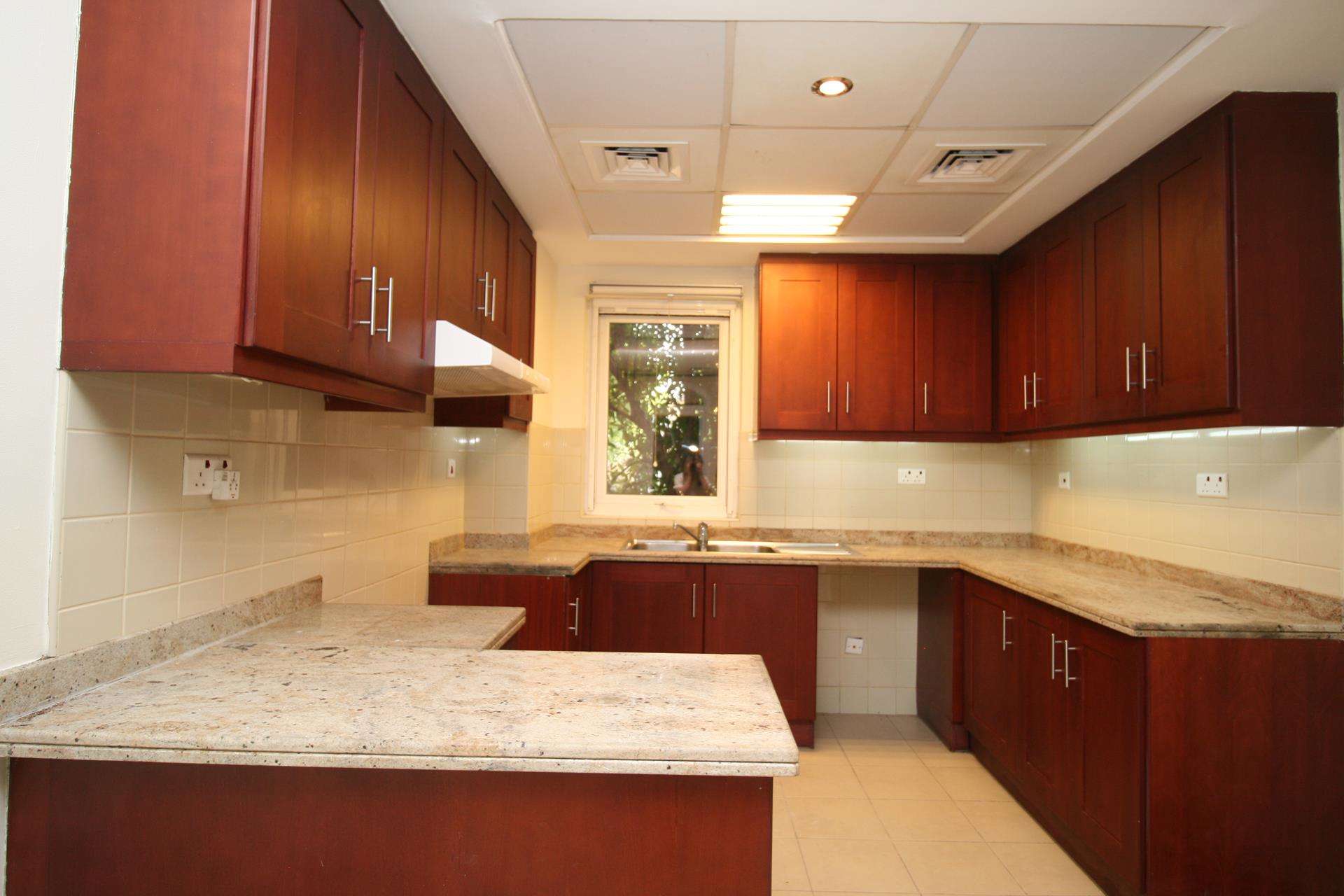 Interior of Palmera Villa kitchen and staircase in Arabian Ranches, 2-bedroom for rent