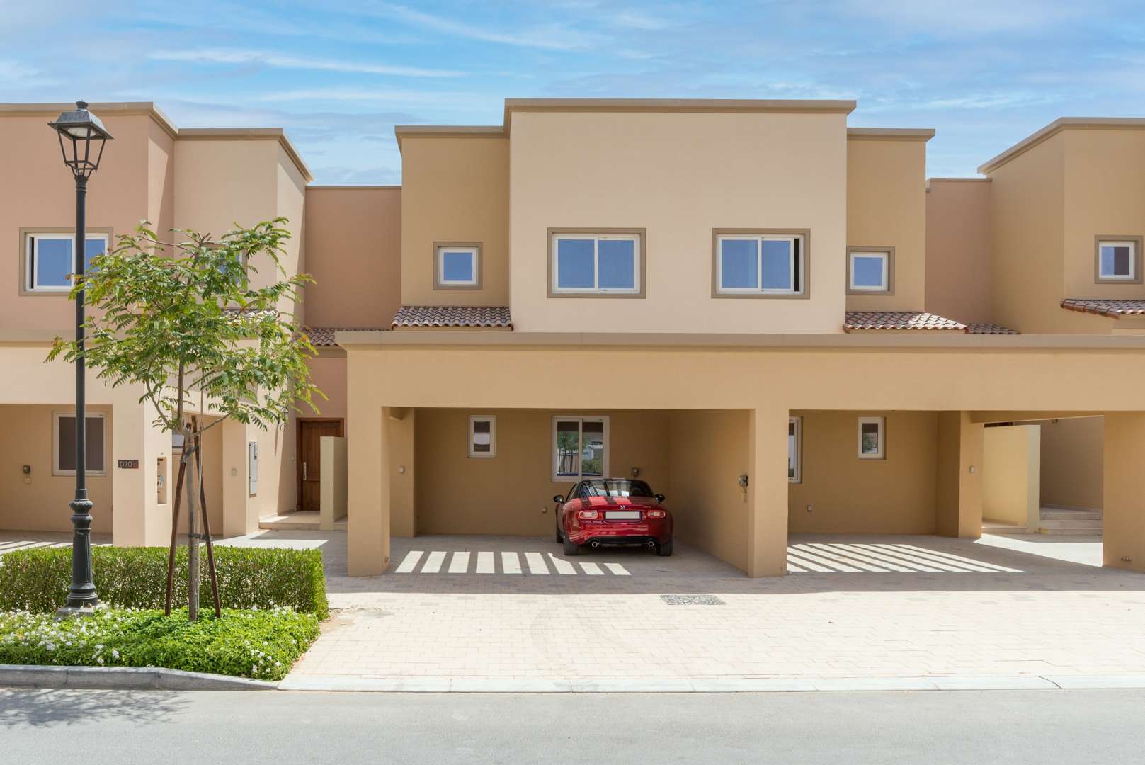 Spacious 2-bedroom townhouse exterior in Amaranta 1, Villanova, Dubai with carport