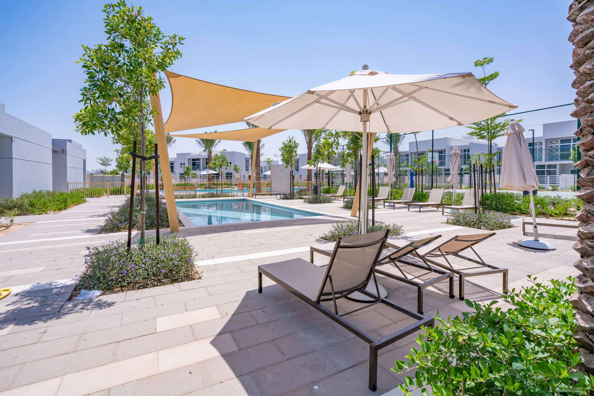 Modern 2-bedroom townhouse exterior in Arabella 2, Mudon, Dubai, with carport and balcony