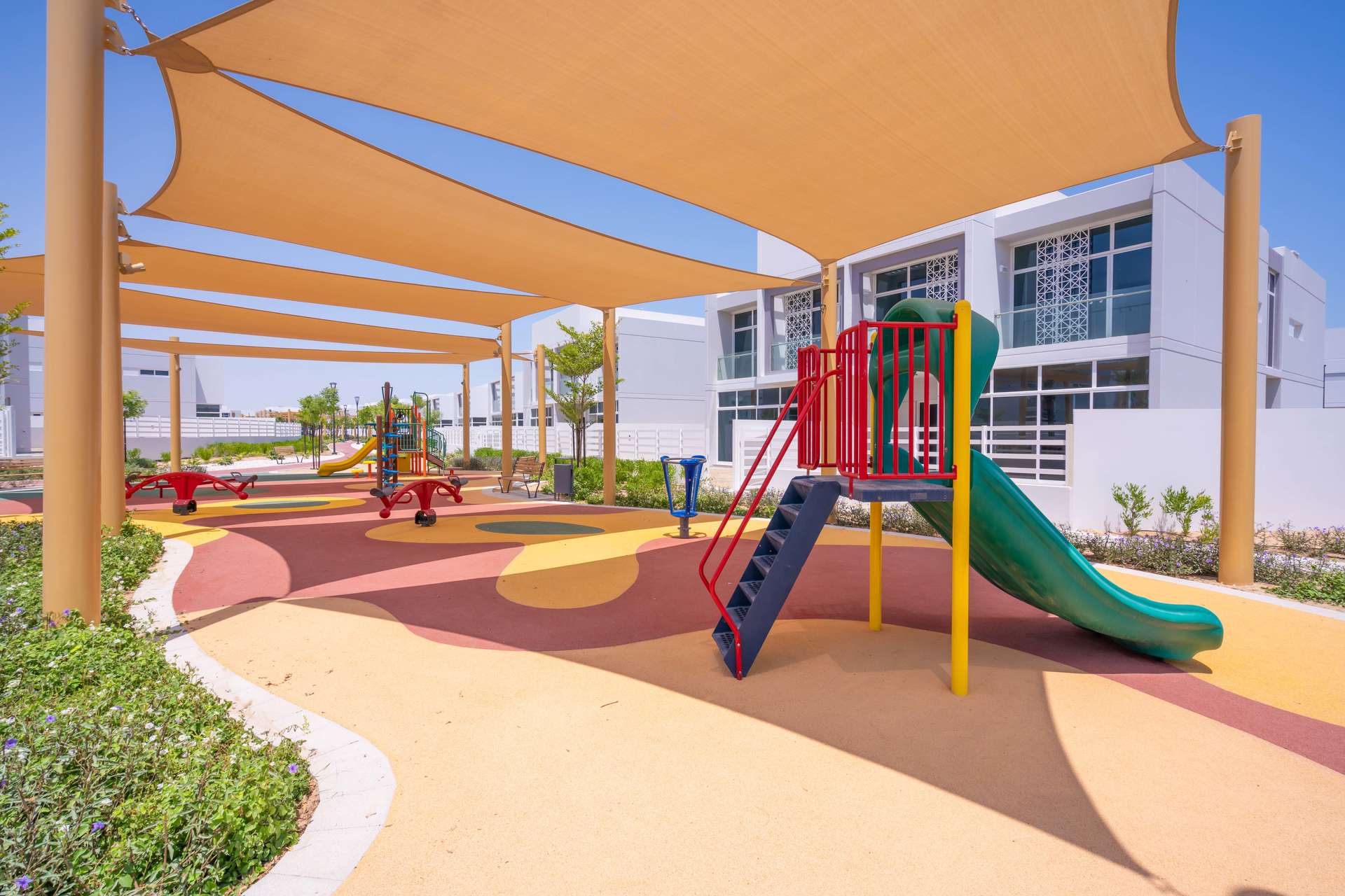 Outdoor pool area with loungers in Arabella Townhouses, Mudon, Dubai