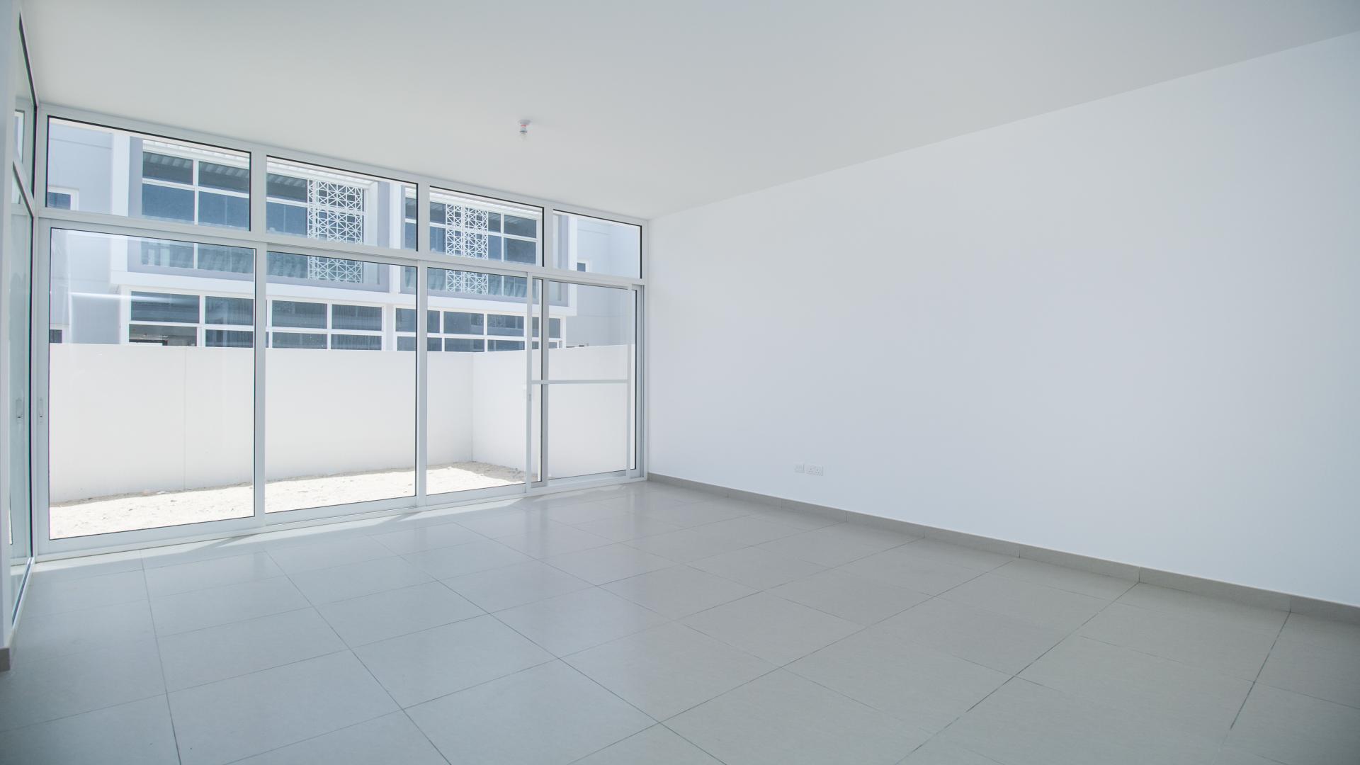 Modern 2-bed townhouse exterior in Arabella Townhouses, Mudon, featuring spacious windows