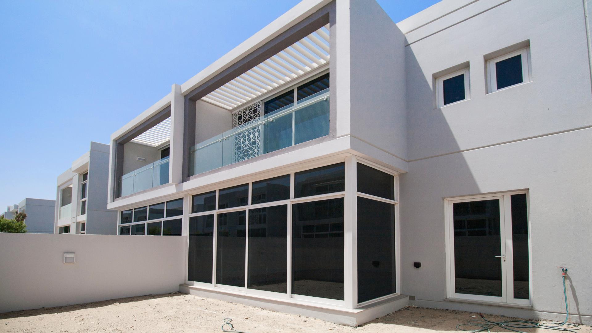 Modern kitchen and living area in Arabella Townhouse, Mudon, with large windows and natural light