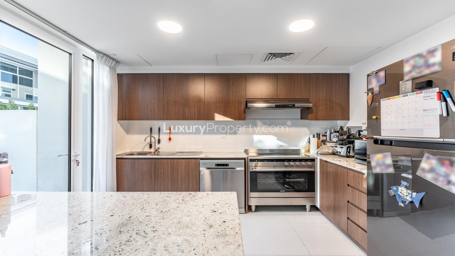 Living room in luxury 2-bedroom townhouse, Mudon Arabella, featuring modern decor and natural light