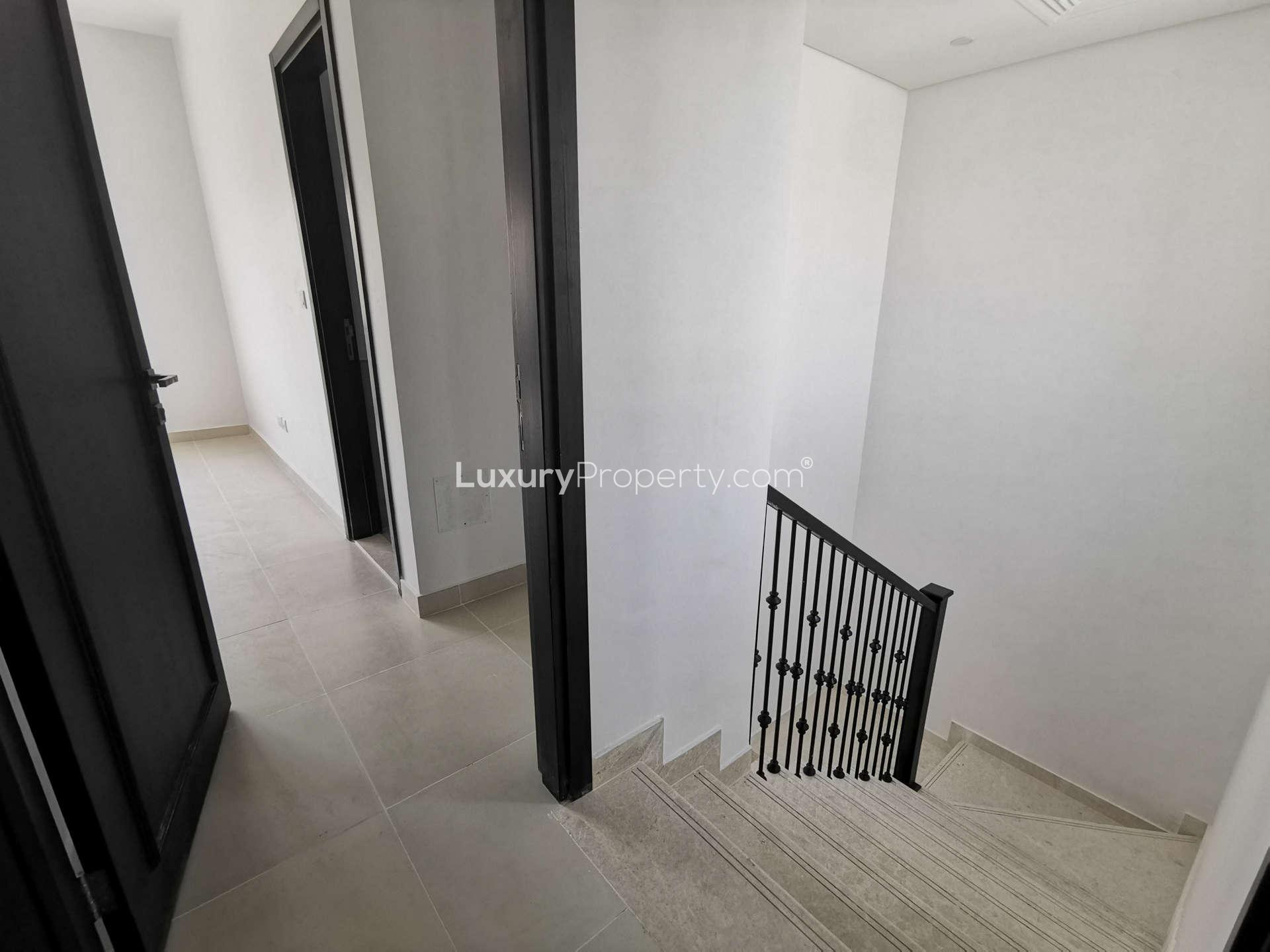 Modern kitchen in 2-bedroom townhouse, Casa Dora, Serena; featuring dark cabinets and sleek countertops
