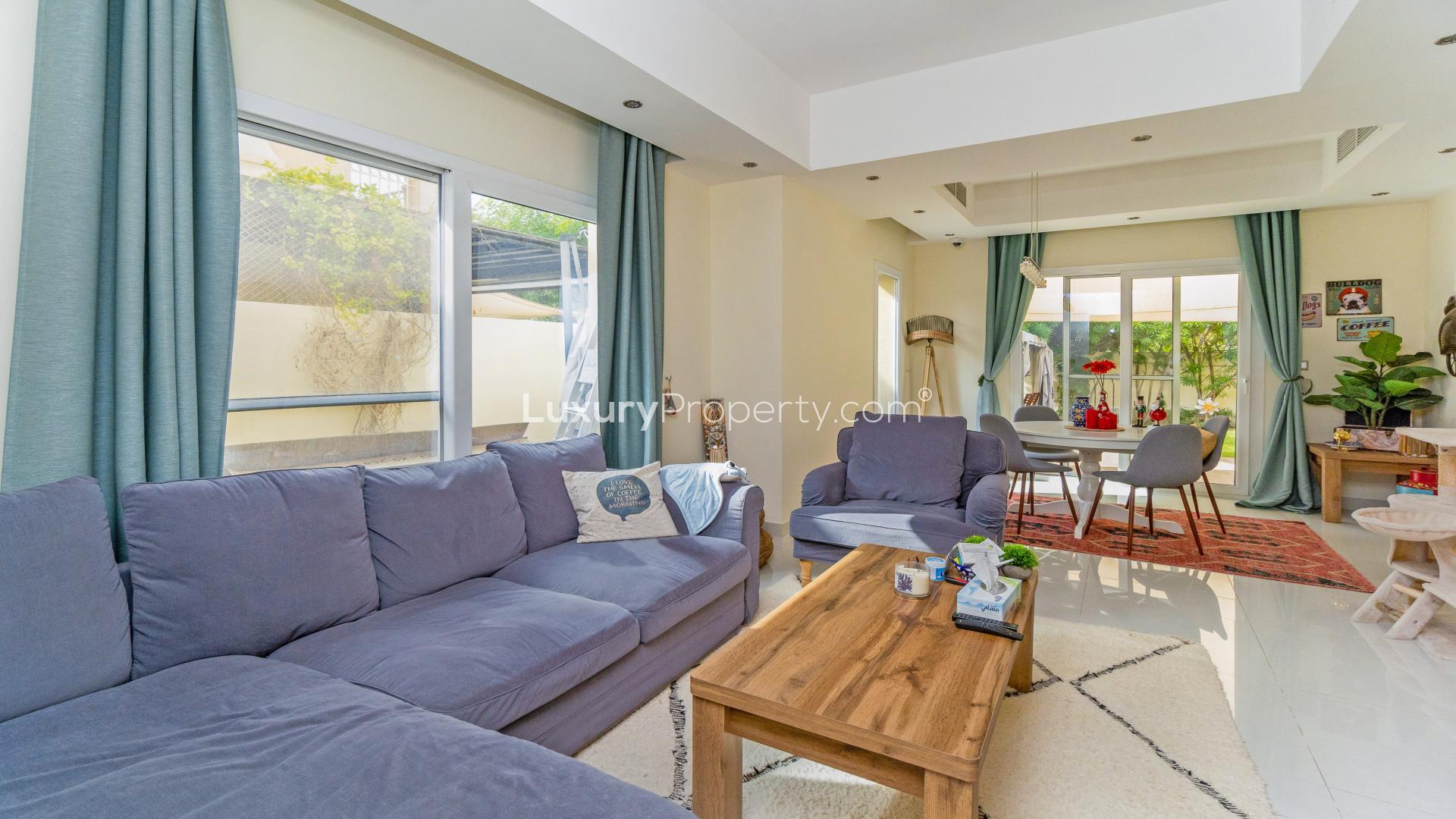 Modern kitchen in Maeen townhouse, The Lakes community, featuring sleek white cabinets and appliances