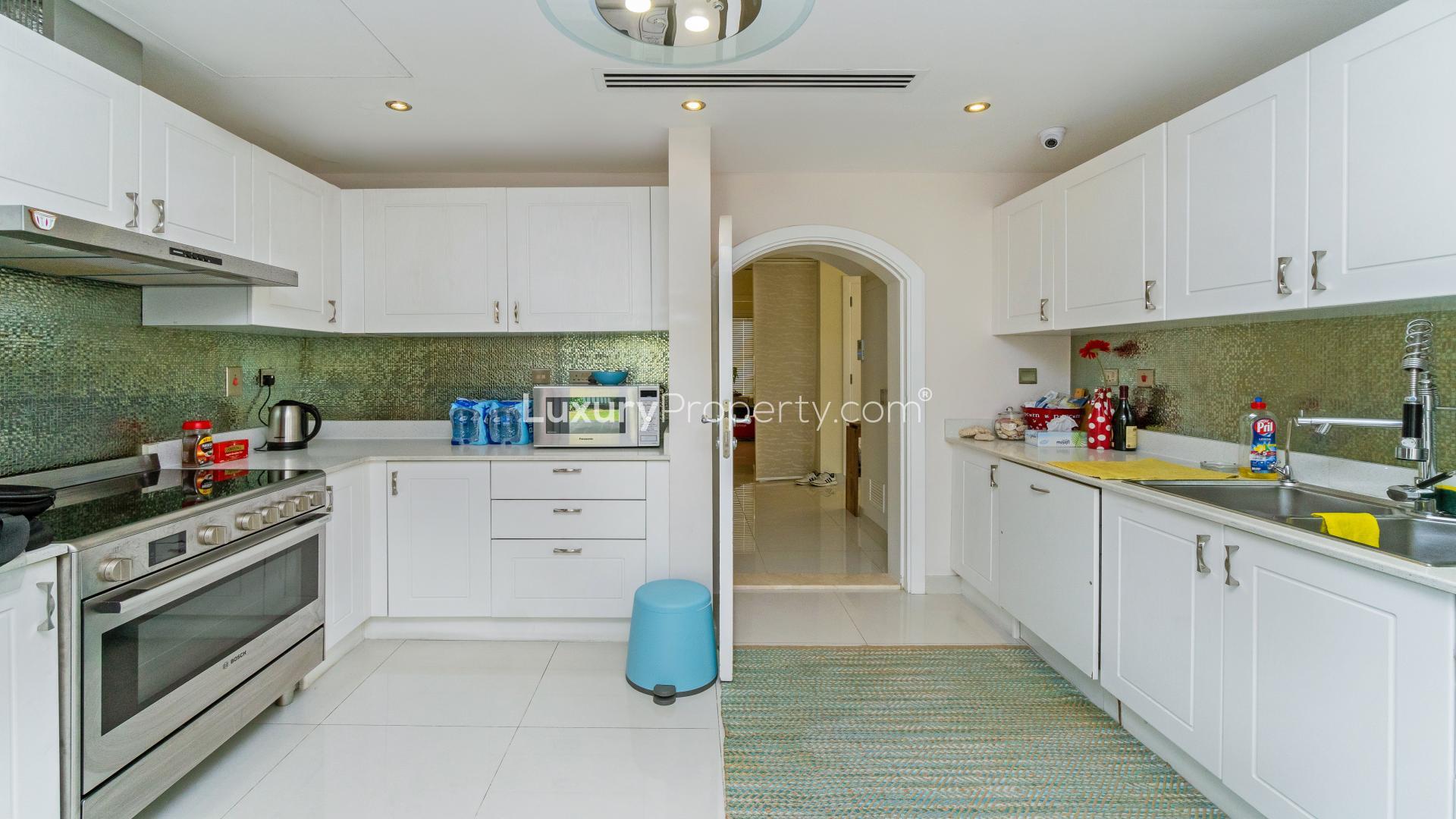 Modern kitchen in two-bedroom townhouse, Maeen, The Lakes, with sleek appliances and outdoor access