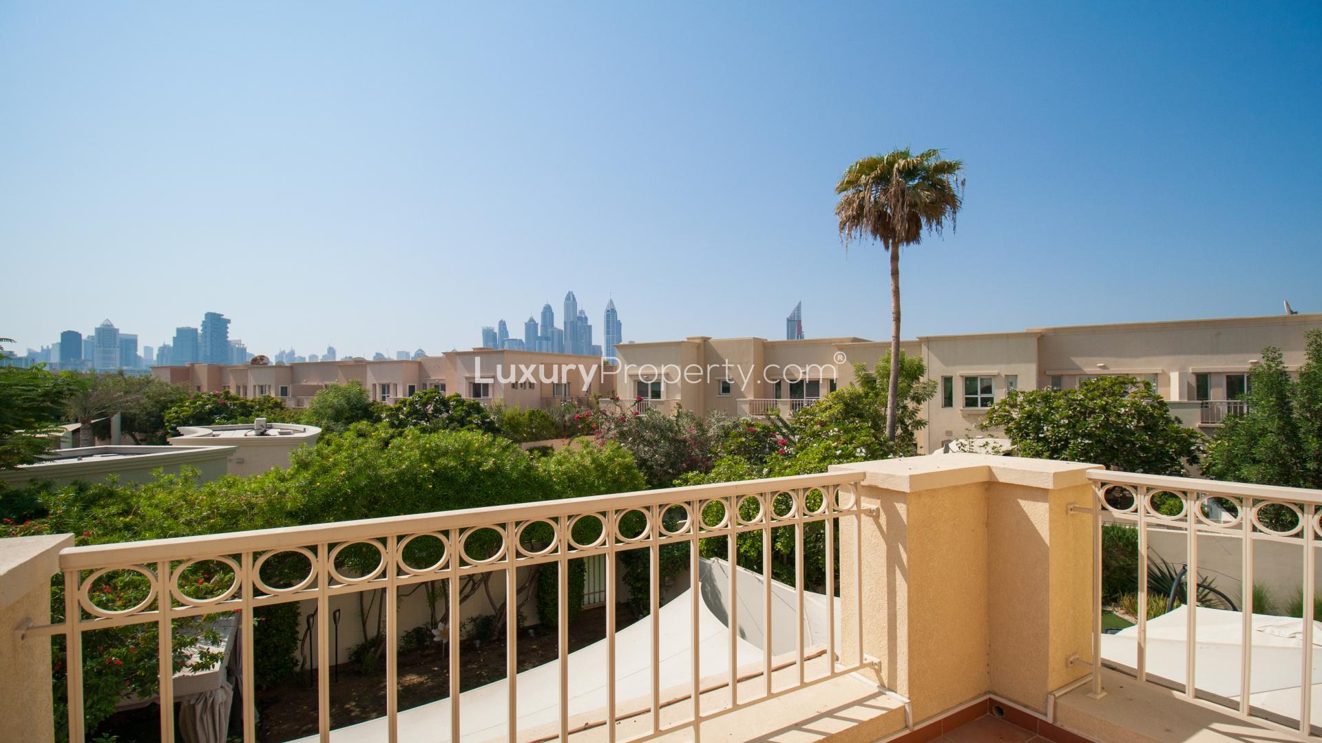 Outdoor shaded patio area with greenery in Maeen villa, The Lakes community