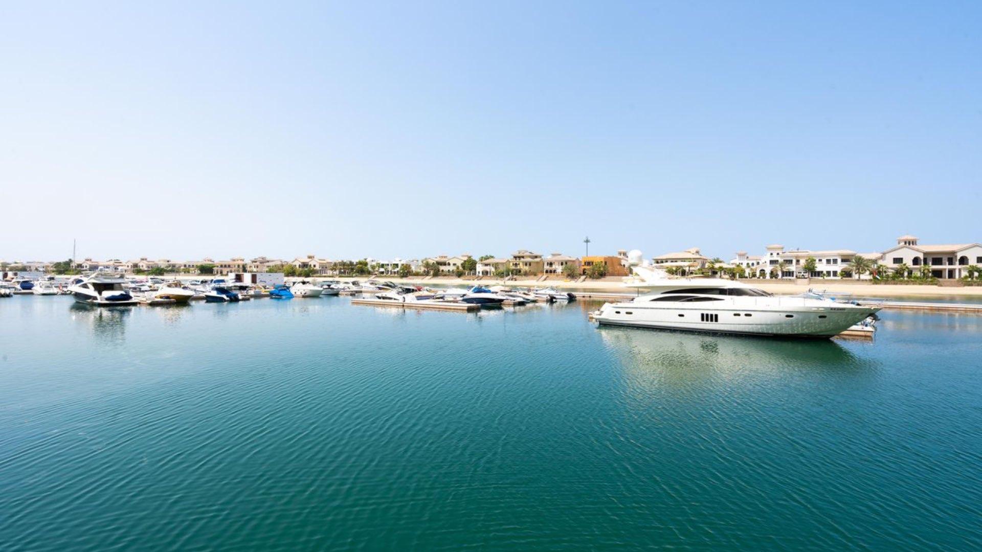 "Spacious townhouse balcony with marina view in Marina Residences, Palm Jumeirah, for sale.","View of Palm Jumeirah Marina from townhouse for sale in Marina Residences.",Townhouse exterior view, Marina Residences, Palm Jumeirah, near waterfront, for sale