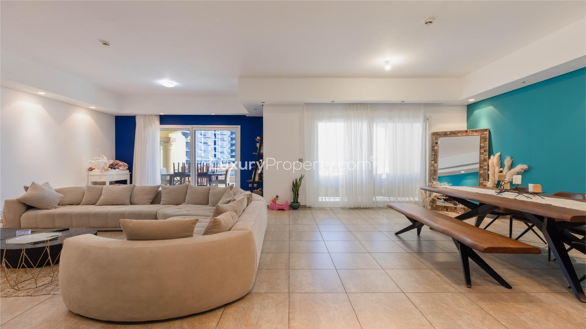 "Sea view from Marina Residences townhouse in Palm Jumeirah, Dubai, featuring waterfront and yachts.",Modern living area in Palm Jumeirah townhouse with stylish decor and natural light