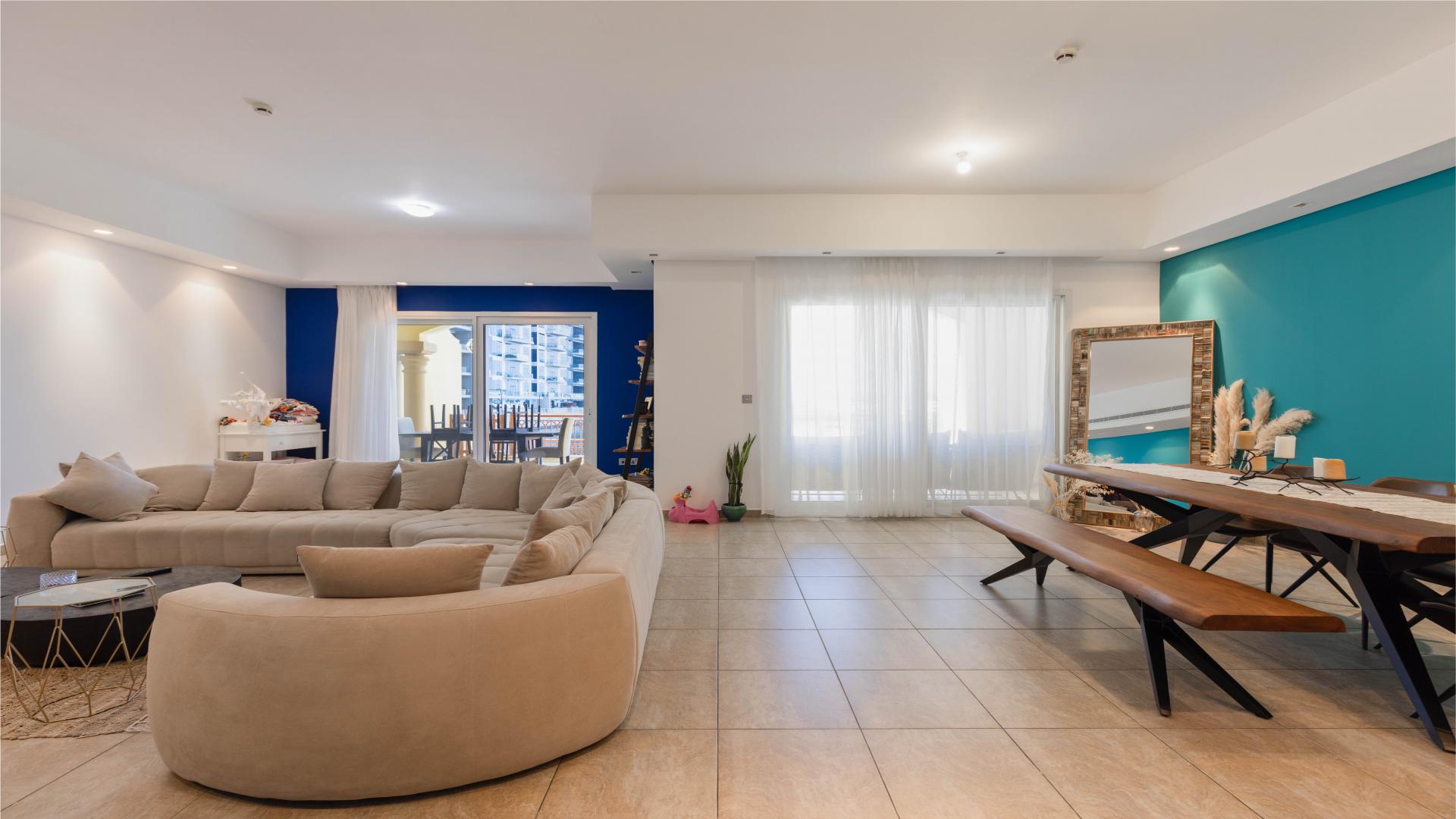 "Sea view from Marina Residences townhouse in Palm Jumeirah, Dubai, featuring waterfront and yachts.",Modern living area in Palm Jumeirah townhouse with stylish decor and natural light