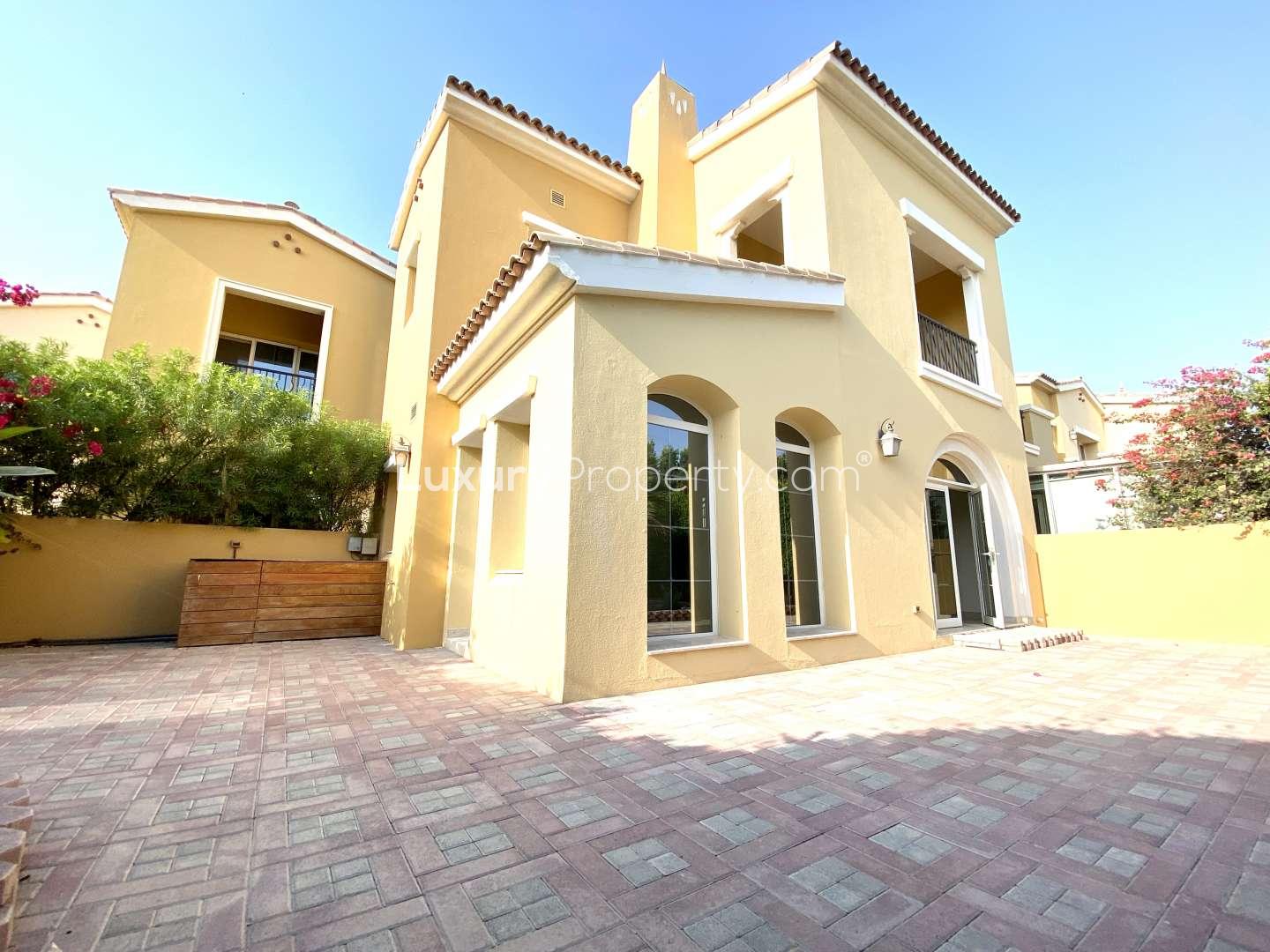 "Elegant arched entryway of upgraded Vastu-compliant townhouse in Palmera, Arabian Ranches, for sale.",Upgraded townhouse interior with marble floors and staircase in Palmera, Arabian Ranches