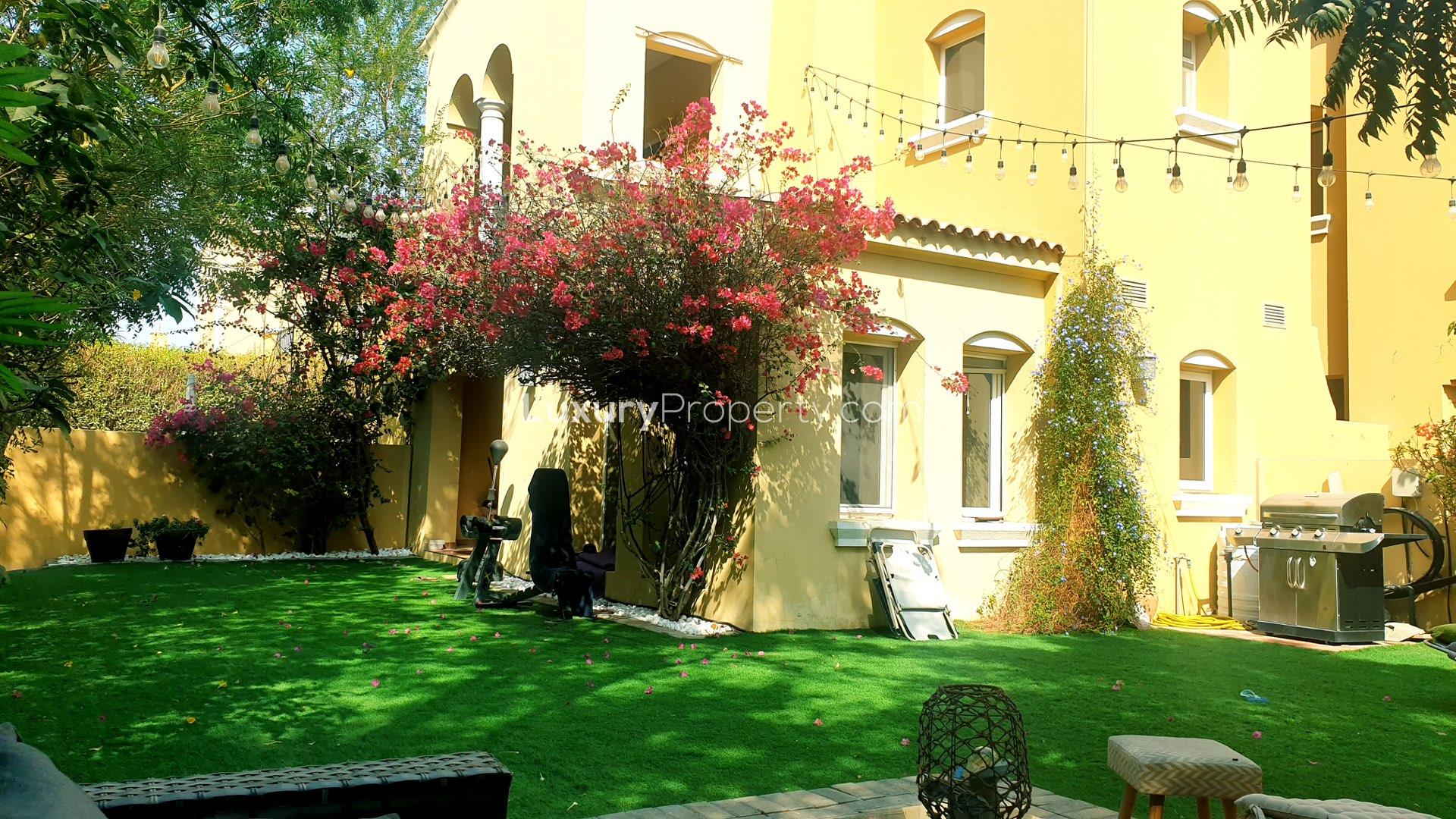 Beautiful garden of two-bedroom villa in Palmera, Arabian Ranches with lush greenery