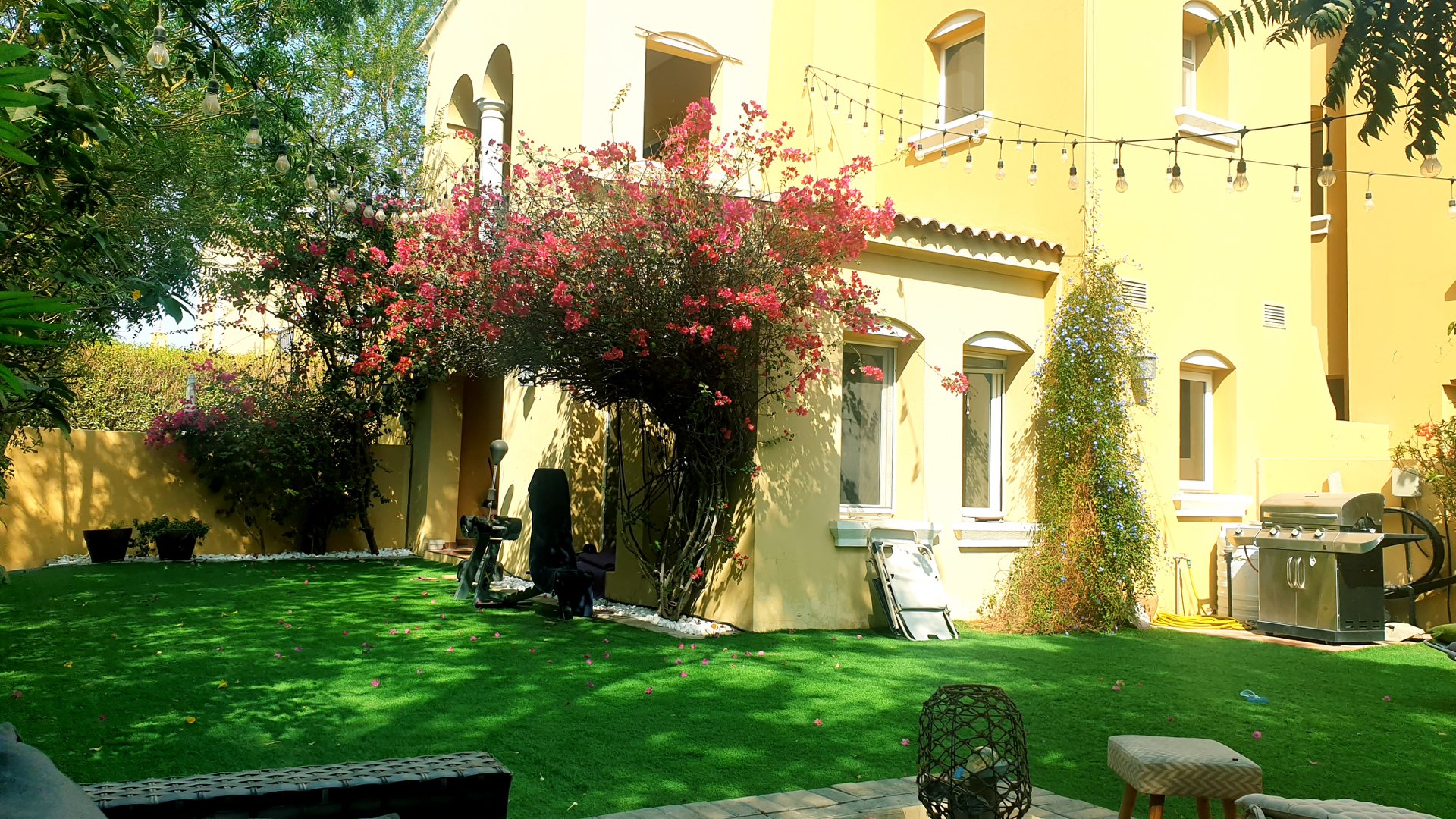 Beautiful garden of two-bedroom villa in Palmera, Arabian Ranches with lush greenery