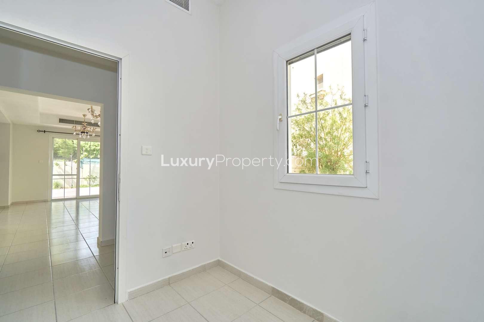 Bright living area in 2-bedroom villa, Springs 2, Emirates Living, with chandeliers and windows