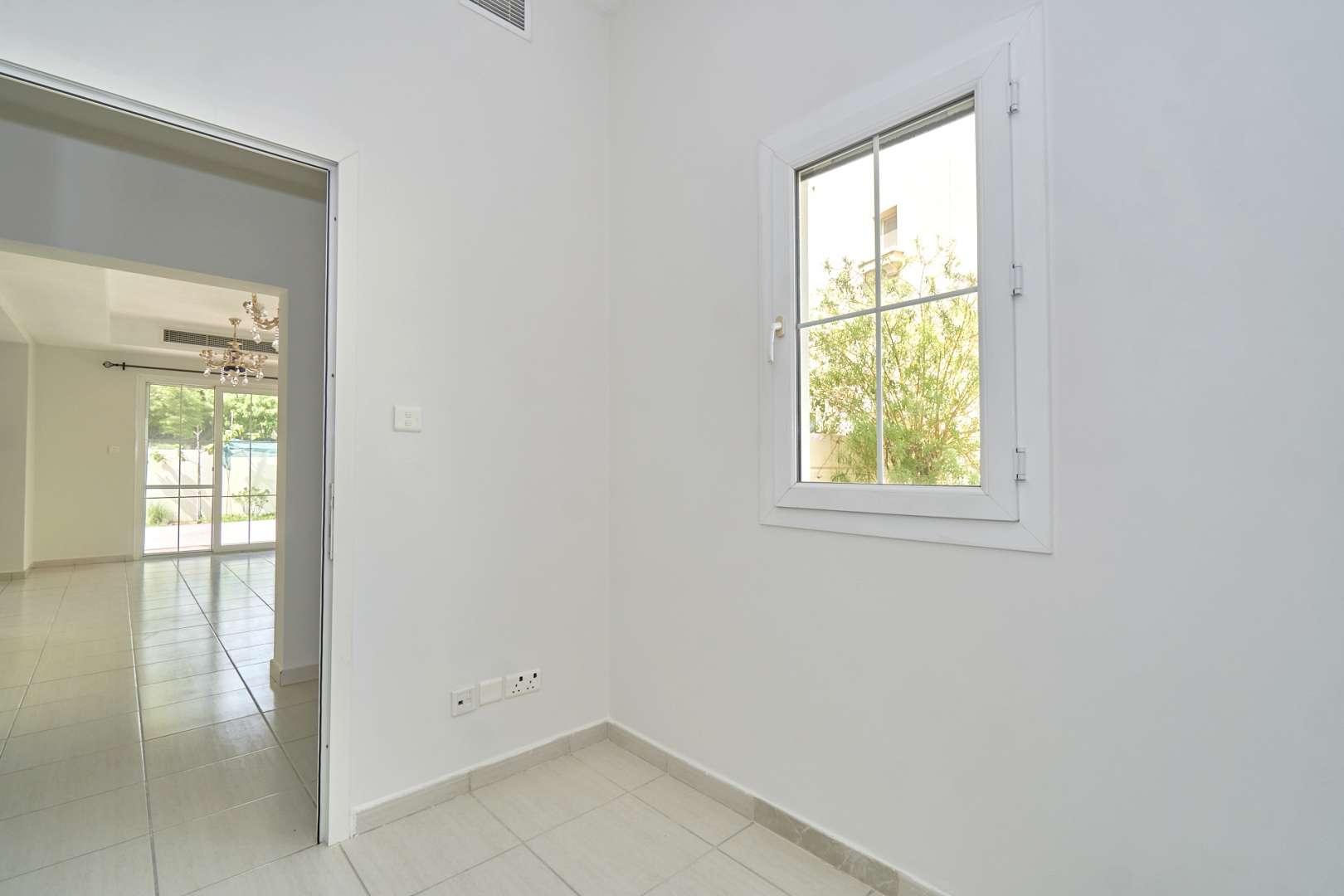 Bright living area in 2-bedroom villa, Springs 2, Emirates Living, with chandeliers and windows