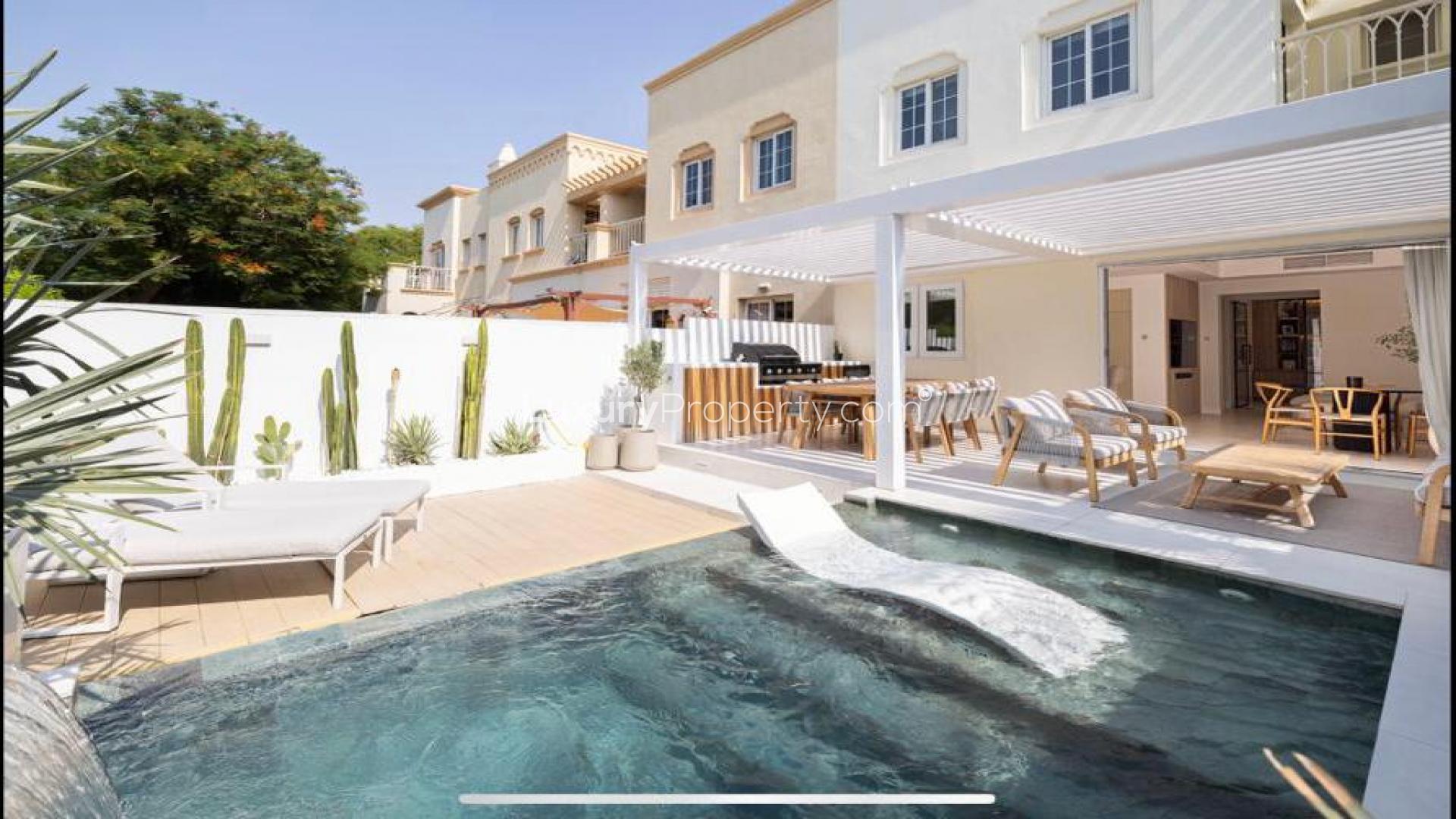 "Luxurious villa with private pool and patio in The Springs, Springs 12 community.",Luxurious villa patio with pool and outdoor seating in Springs 12 community