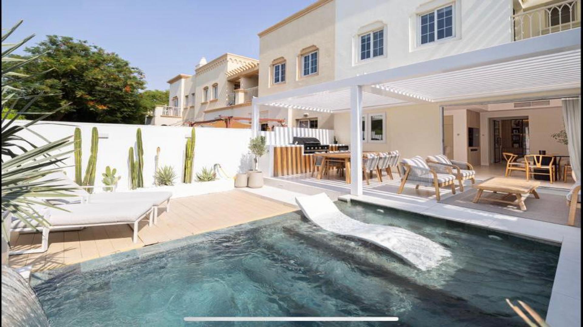 "Luxurious villa with private pool and patio in The Springs, Springs 12 community.",Luxurious villa patio with pool and outdoor seating in Springs 12 community