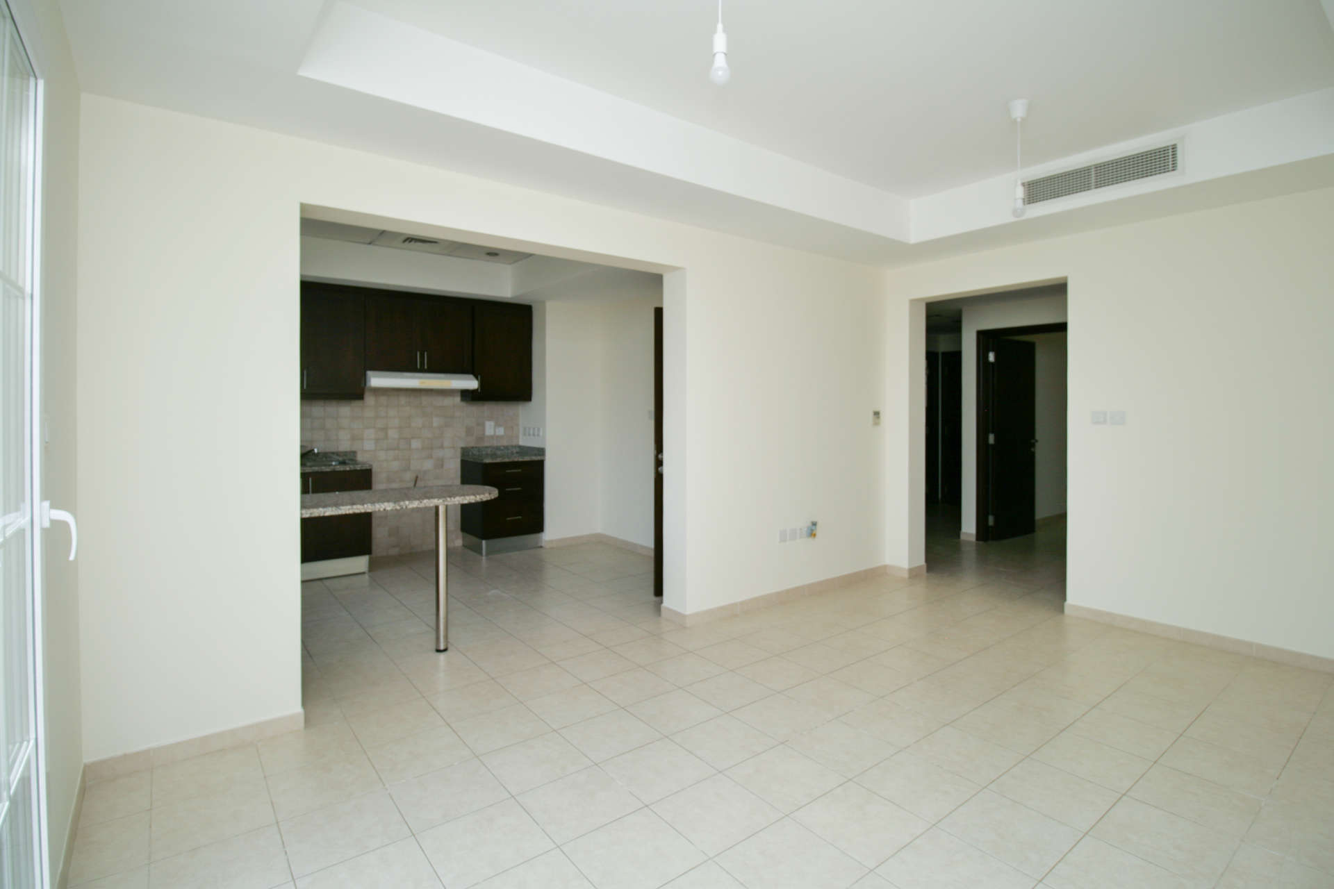 Empty room with tiled floor and large window in Alma villa, Arabian Ranches Dubai