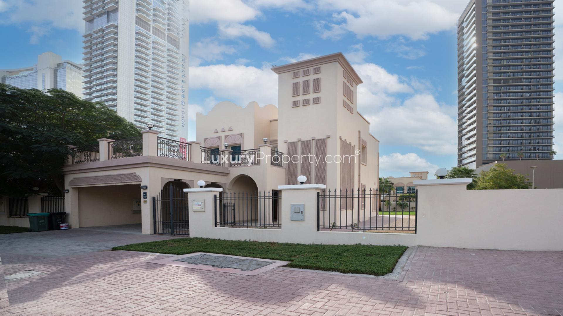 Bright living room with large windows in Jumeirah Village Triangle villa for rent