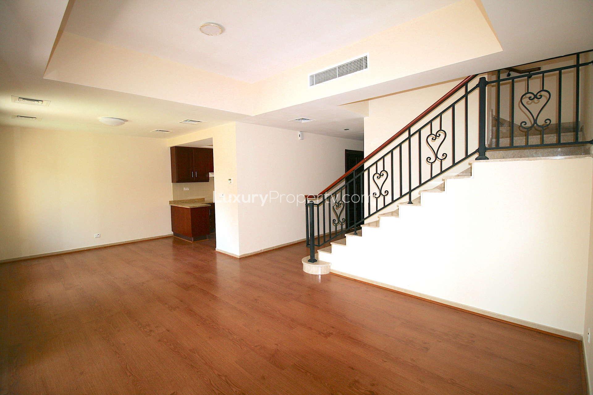 Spacious living room with wooden floors in Palmera 3 villa, Arabian Ranches rental property