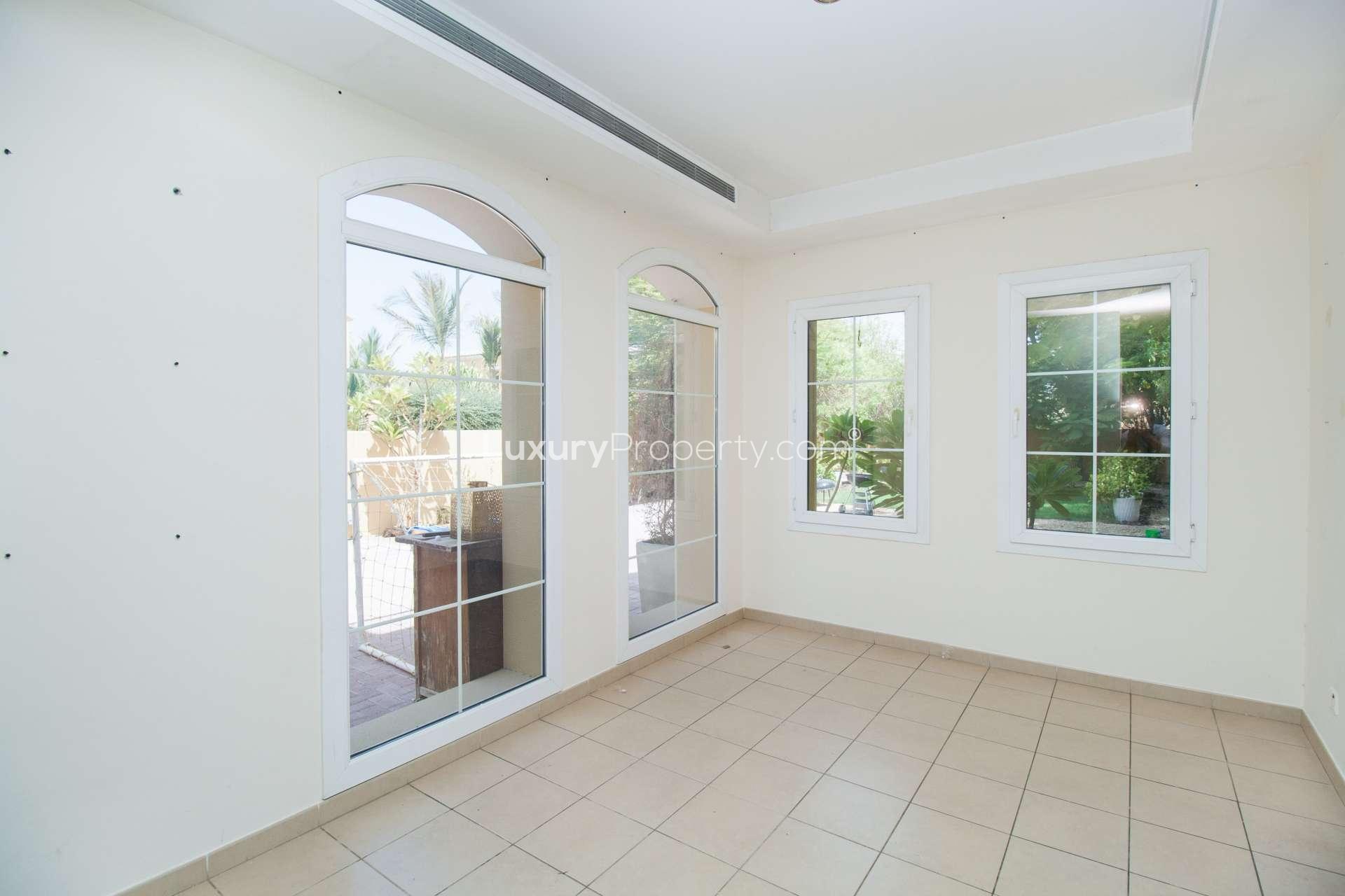 Empty room with tiled floor and large windows in Palmera 4 villa, Arabian Ranches