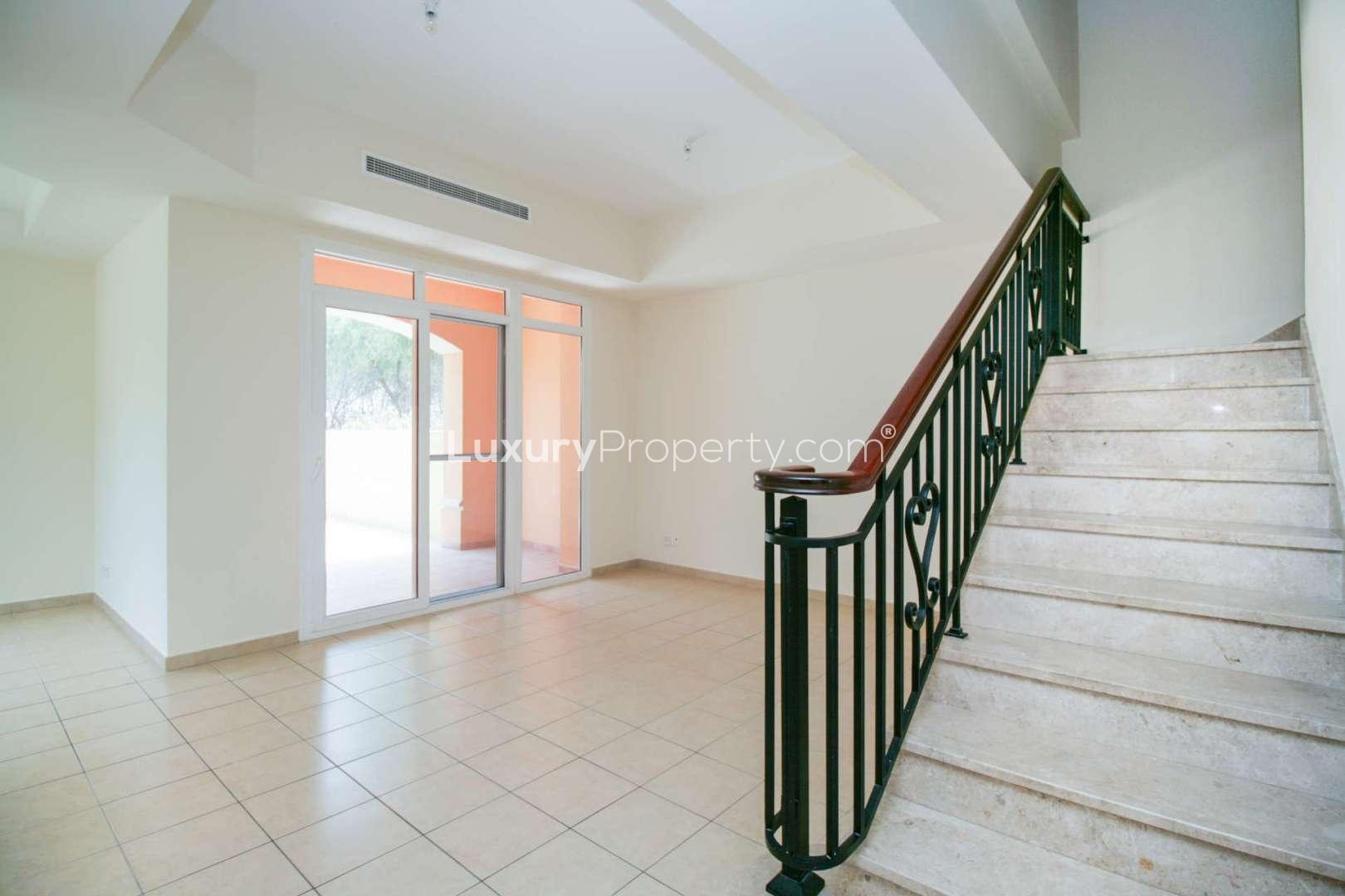 Spacious living area in Palmera 1 villa, Arabian Ranches, with garden view through large windows