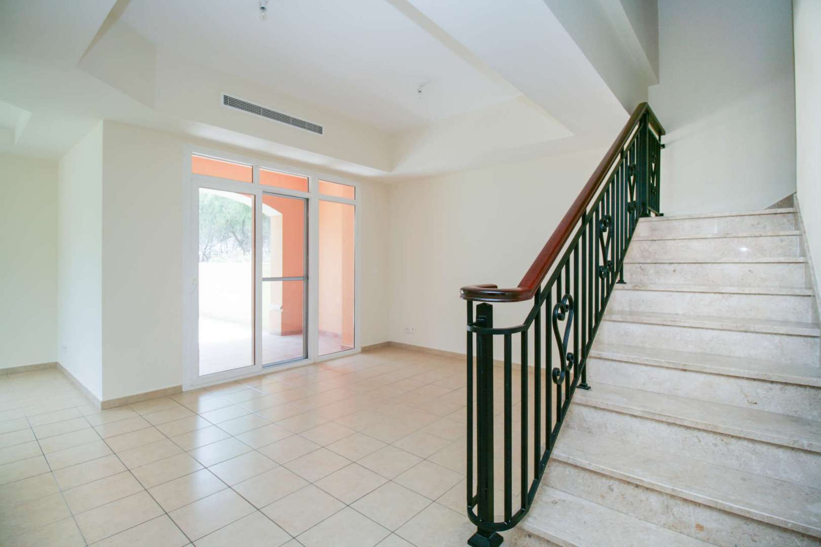 Spacious living area in Palmera 1 villa, Arabian Ranches, with garden view through large windows