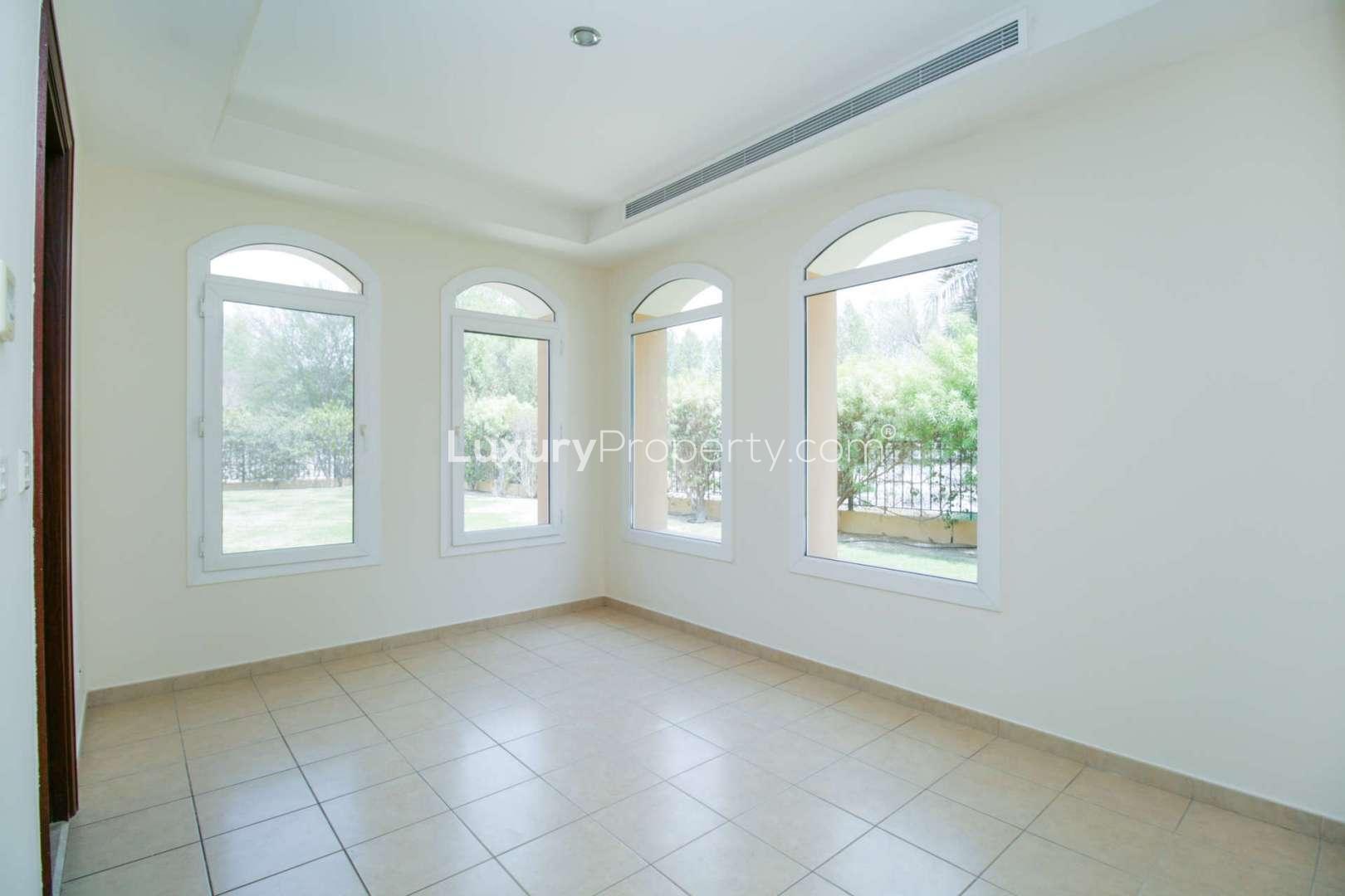 Empty bedroom in Palmera 1 villa, Arabian Ranches with wooden door and balcony access