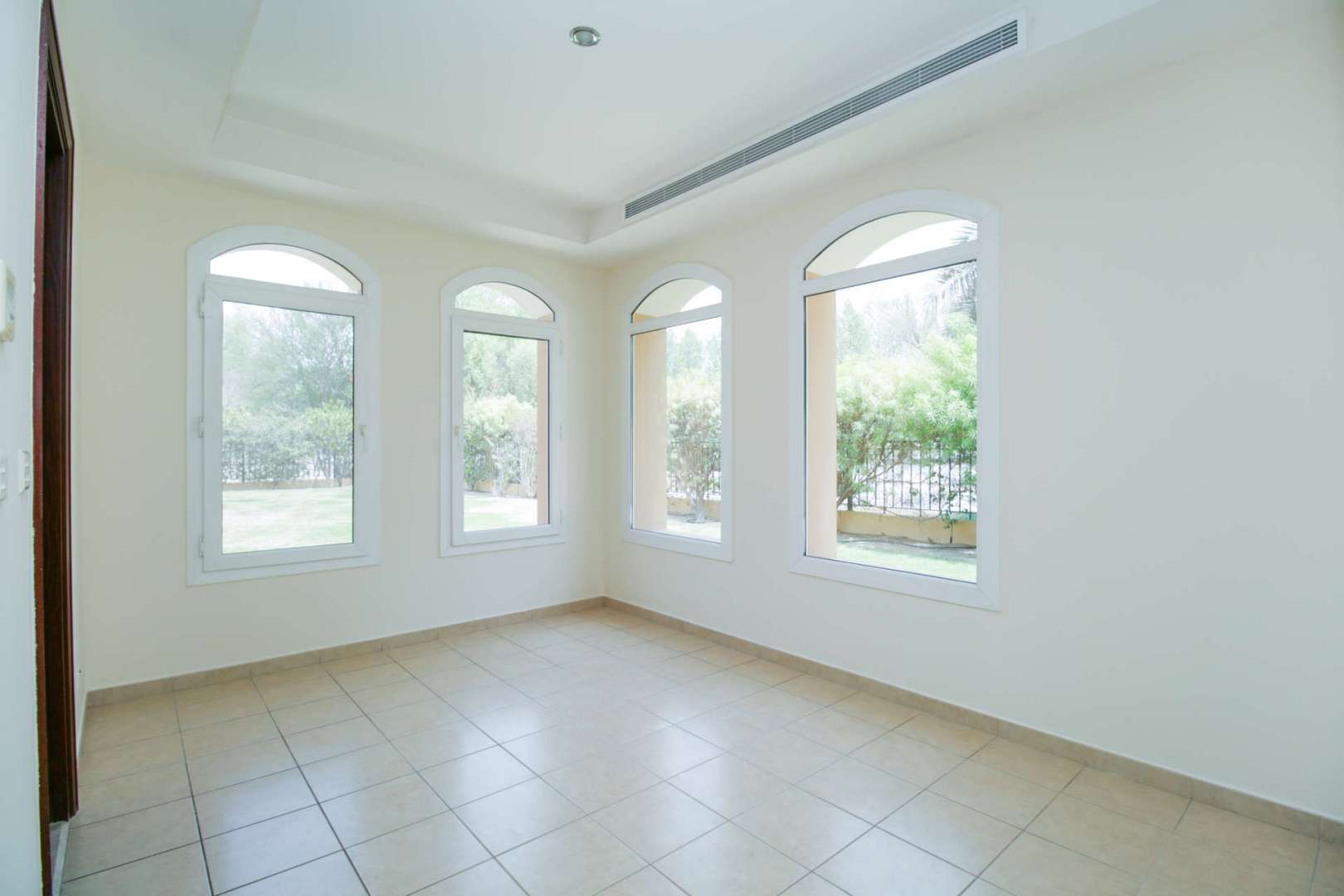 Empty bedroom in Palmera 1 villa, Arabian Ranches with wooden door and balcony access