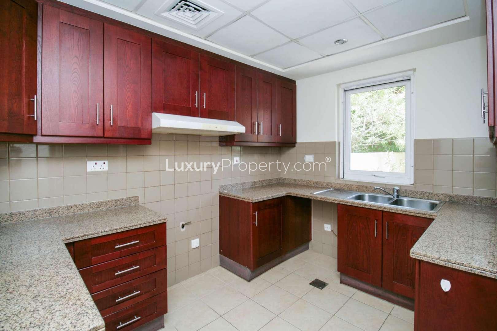 "Bright interior of 2-bedroom villa in Arabian Ranches, Palmera 2, with elegant staircase.",Charming villa kitchen with granite countertops and wooden cabinets in Arabian Ranches, Palmera 2