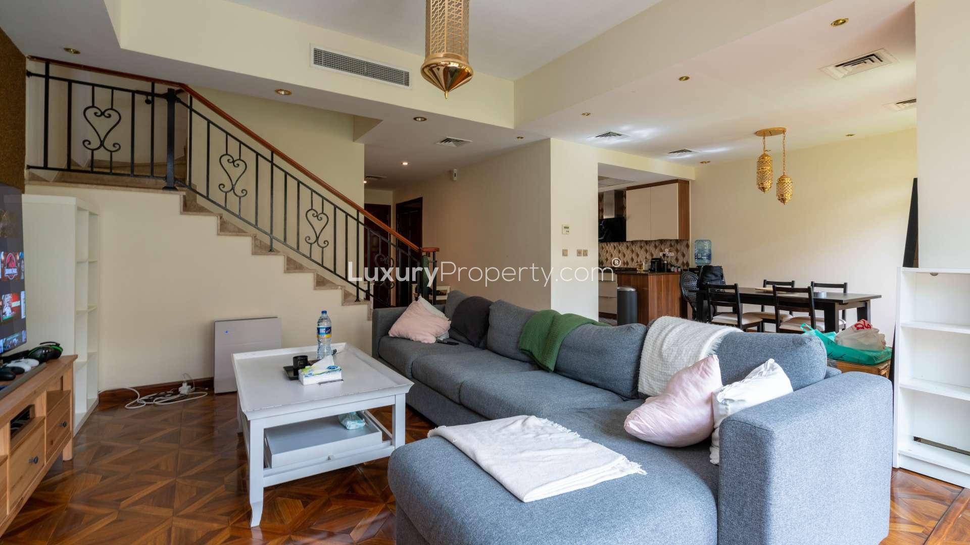 Modern living room in Palmera 4 townhouse, Arabian Ranches, featuring cozy seating and dining area