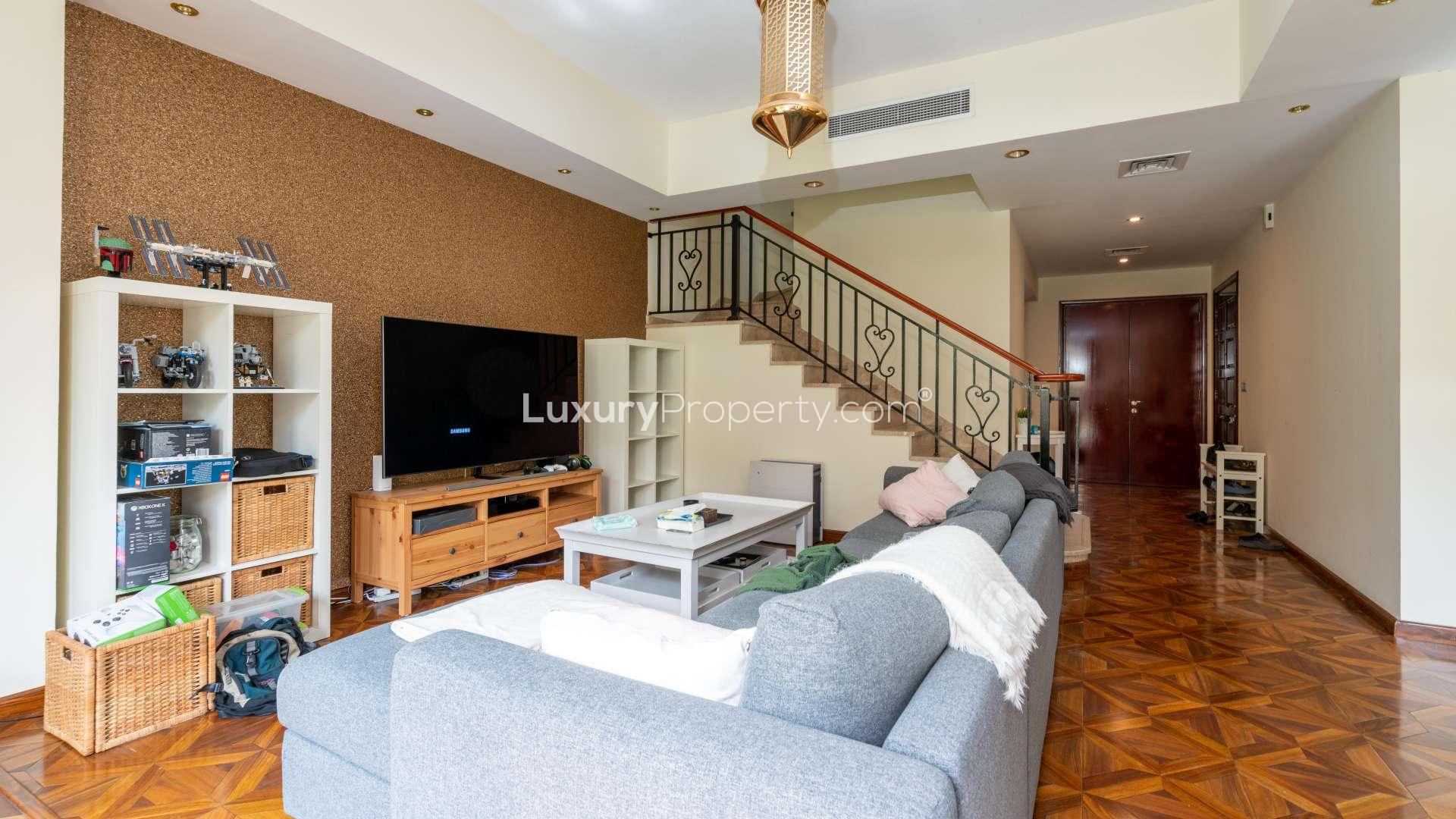 Living room in 2-bedroom townhouse, Palmera 4, Arabian Ranches, with modern decor and garden view