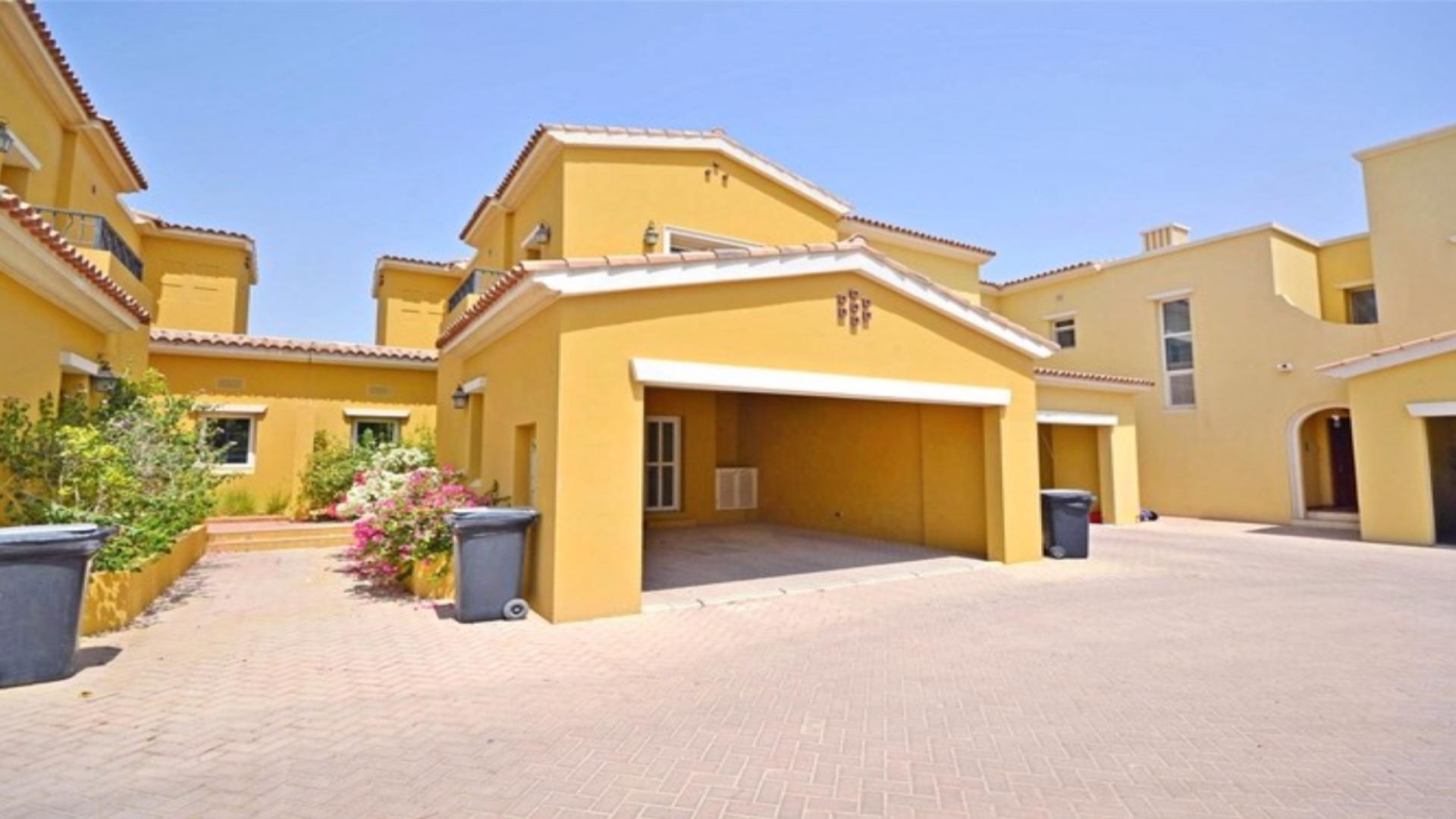 Alt text: "Front view of vacant 2-bedroom townhouse with garage in Palmera, Arabian Ranches.",Vacant 2-bedroom townhouse interior with staircase in Palmera, Arabian Ranches for rent