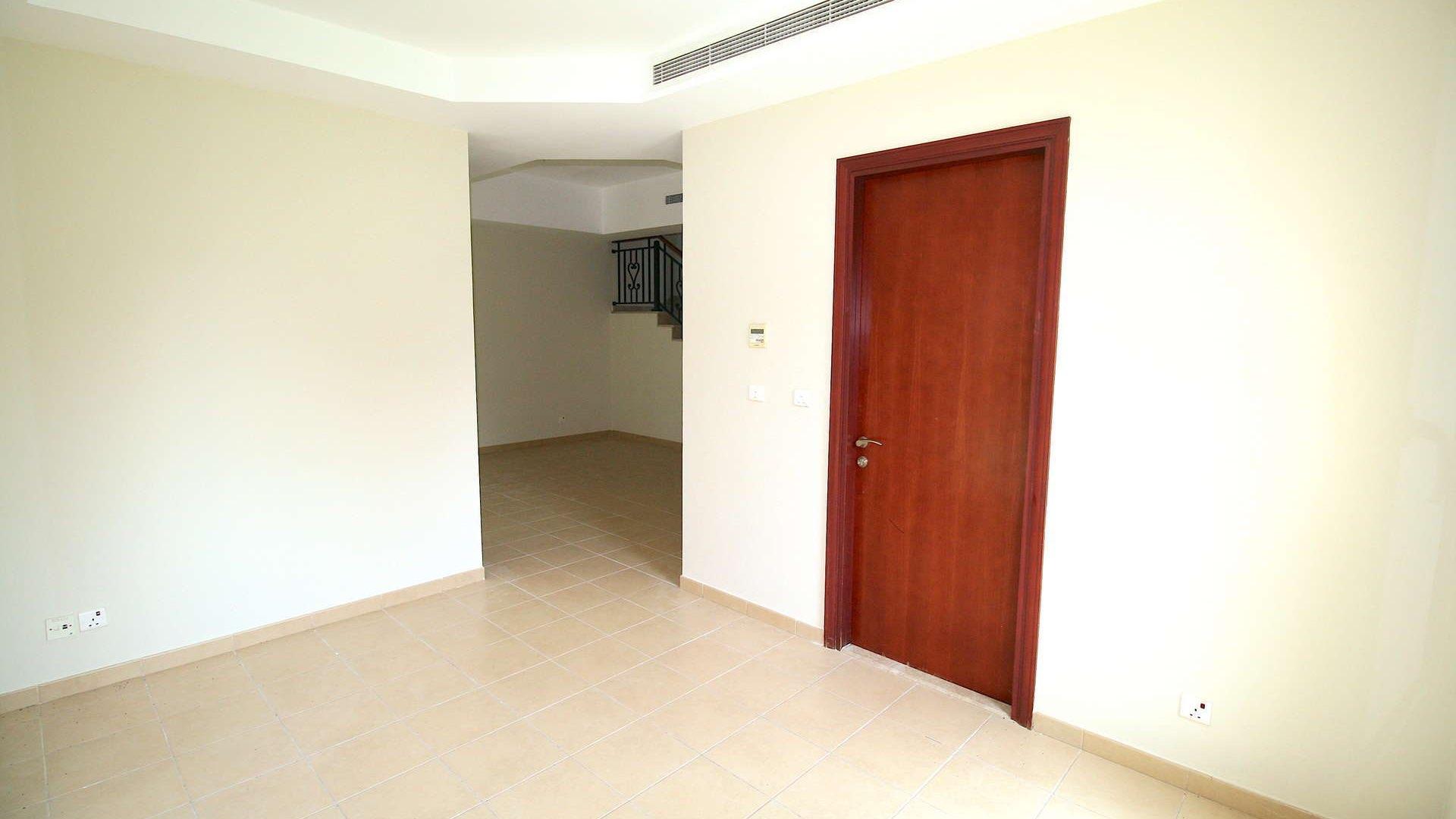 Kitchen with wooden cabinets in two-bedroom villa, Arabian Ranches' Palmera community