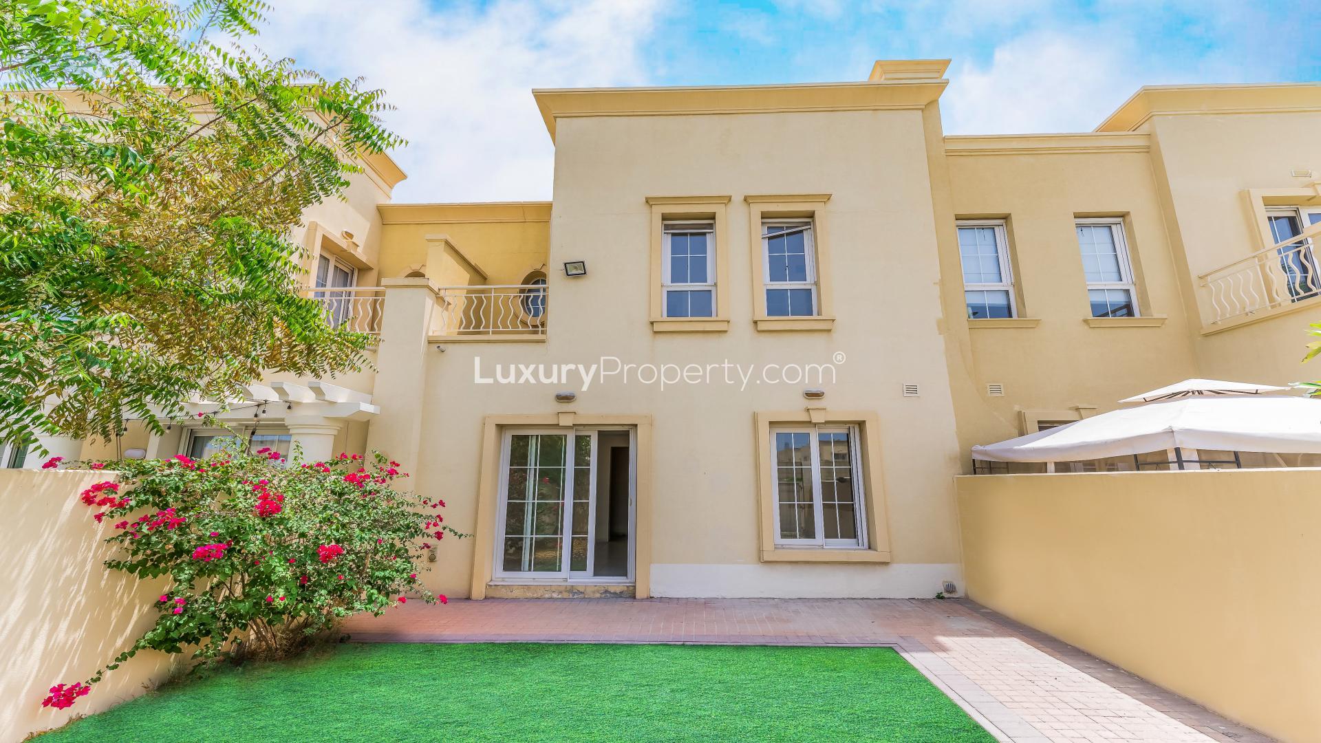 "Springs 7 villa with landscaped garden, 2-bedroom, 2-bathroom, available for rent.",Exterior view of villa with landscaped garden in Springs 7, available for rent