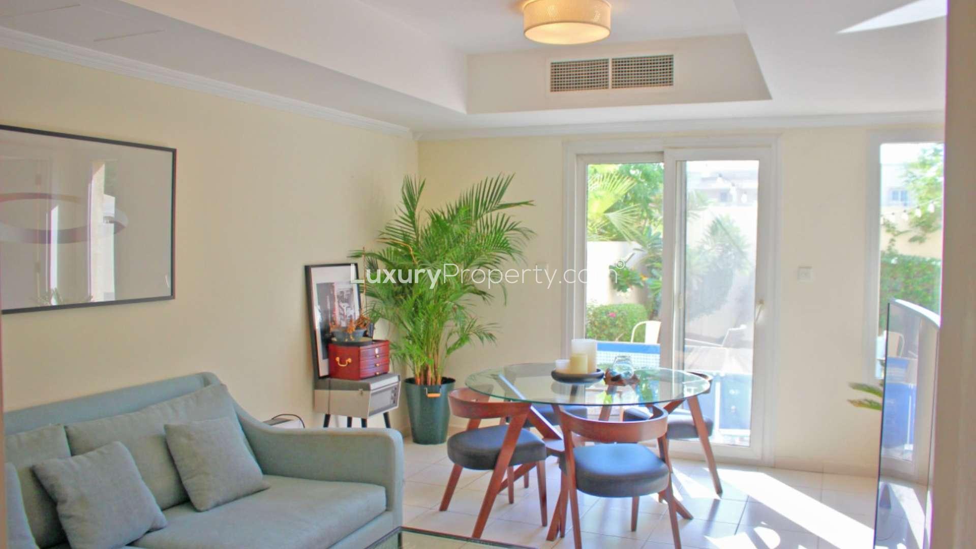 Modern living room in Springs 4 villa with blue sofa and glass dining table