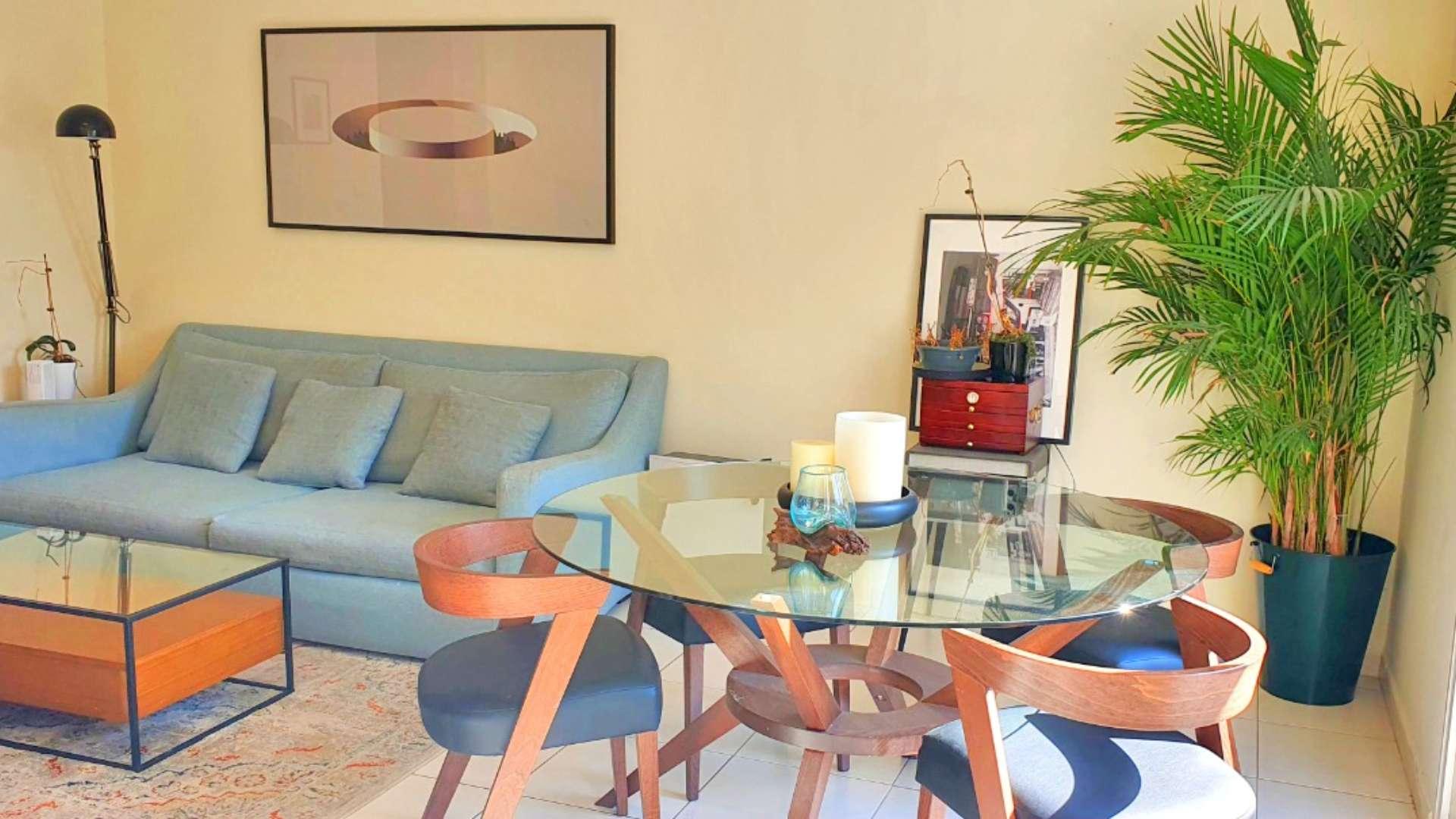 Bright, modern living area in Springs 4 villa with garden view, stylish decor, and natural light