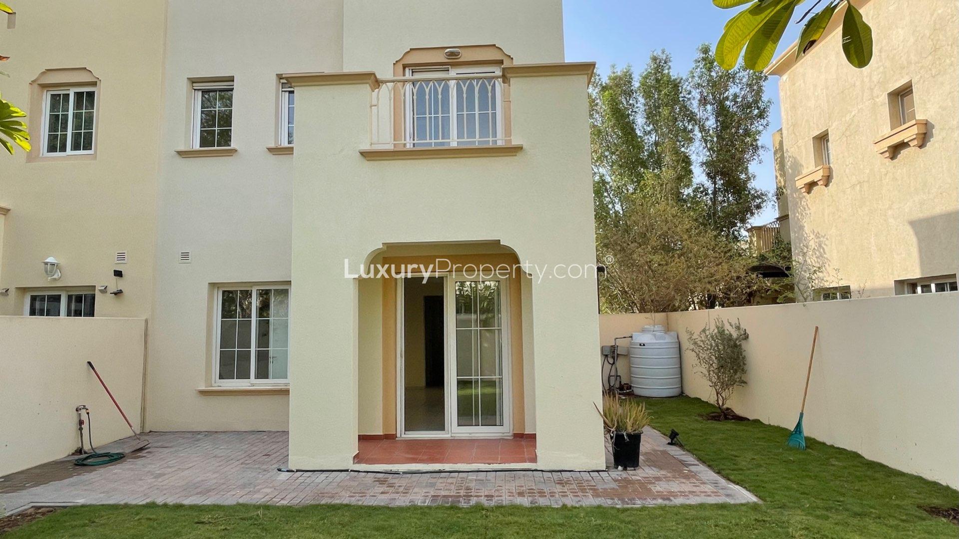 "Spacious living area in 2-bedroom villa for rent, The Springs community, LP14046.",End unit villa exterior with landscaped garden in The Springs community, available for rent