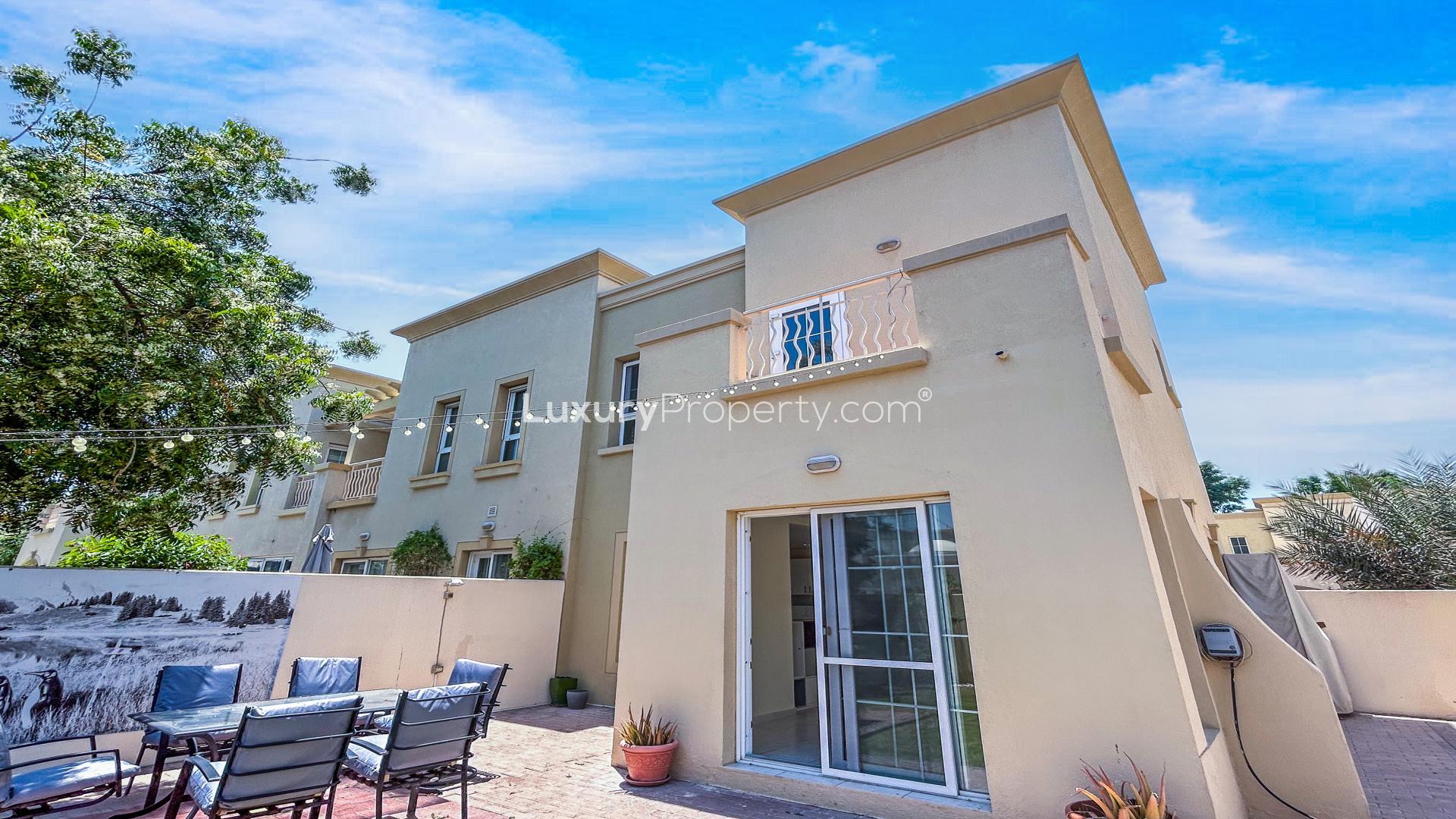 "Bright living area in 2-bed villa, Springs 2, Emirates Living, tiled floor, garden view.",Exterior view of 2-bed villa for rent in Springs 2, Emirates Living Community
