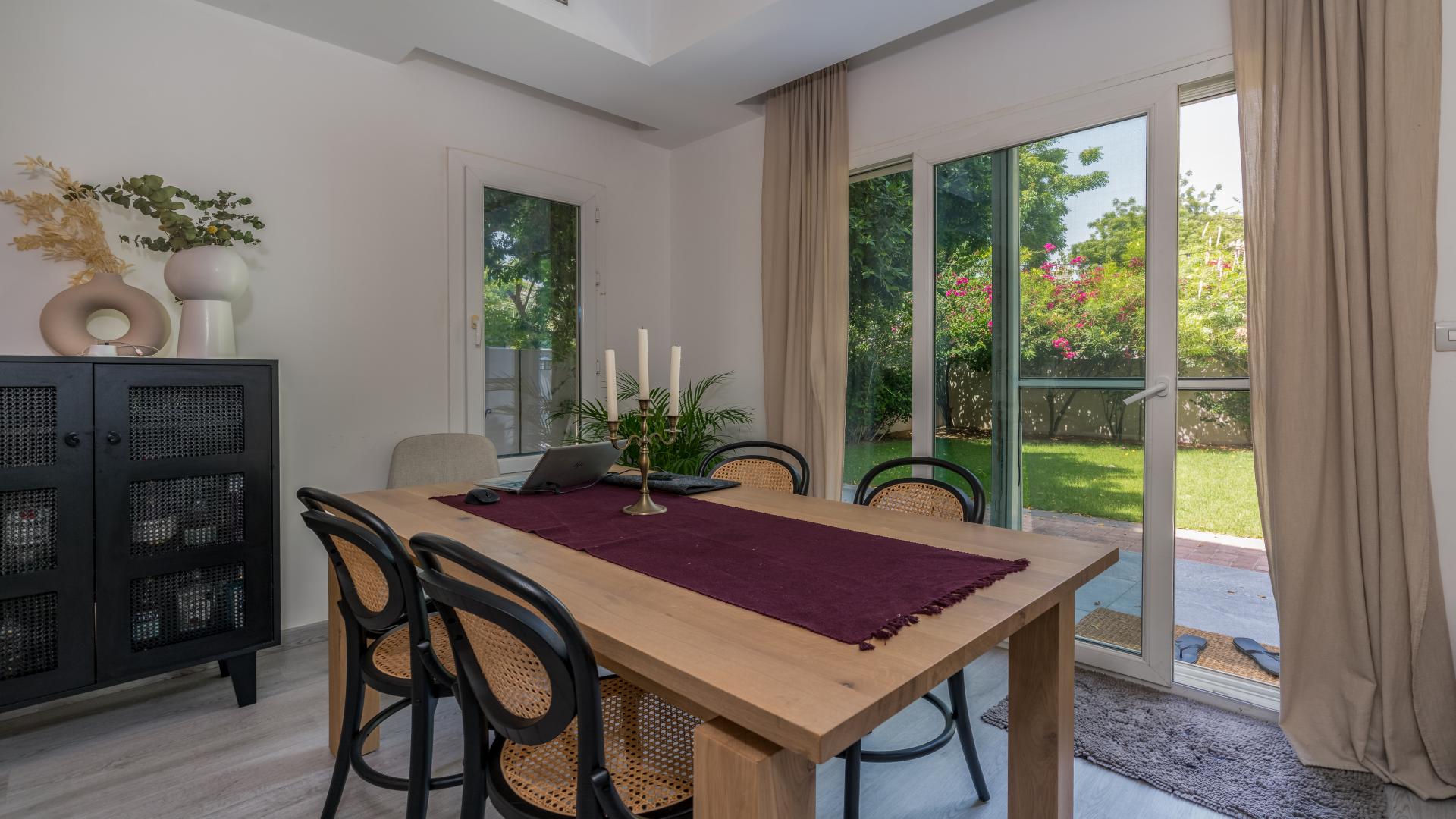 Modern living room in Maeen villa, The Lakes, with stylish decor and garden view
