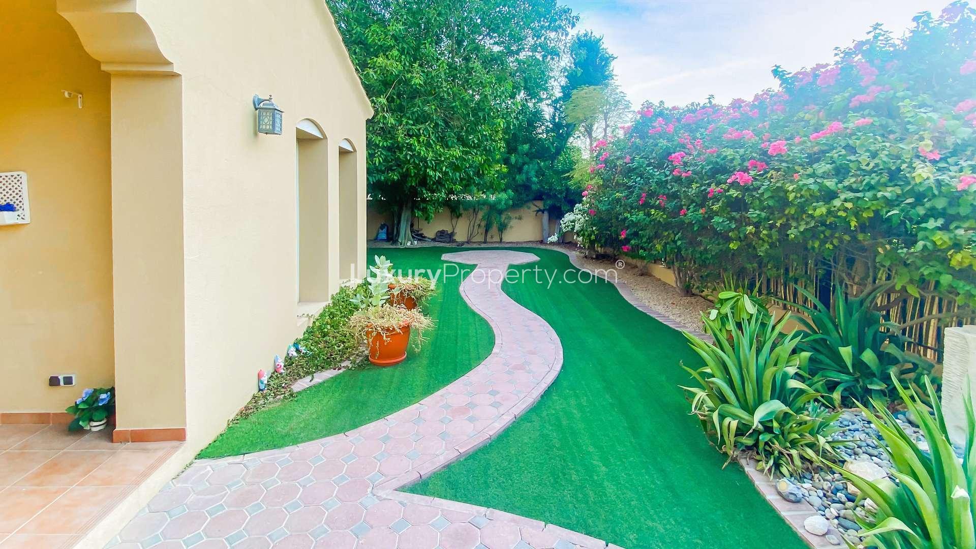 Beautiful park-facing villa entrance with lush garden in Palmera, Arabian Ranches